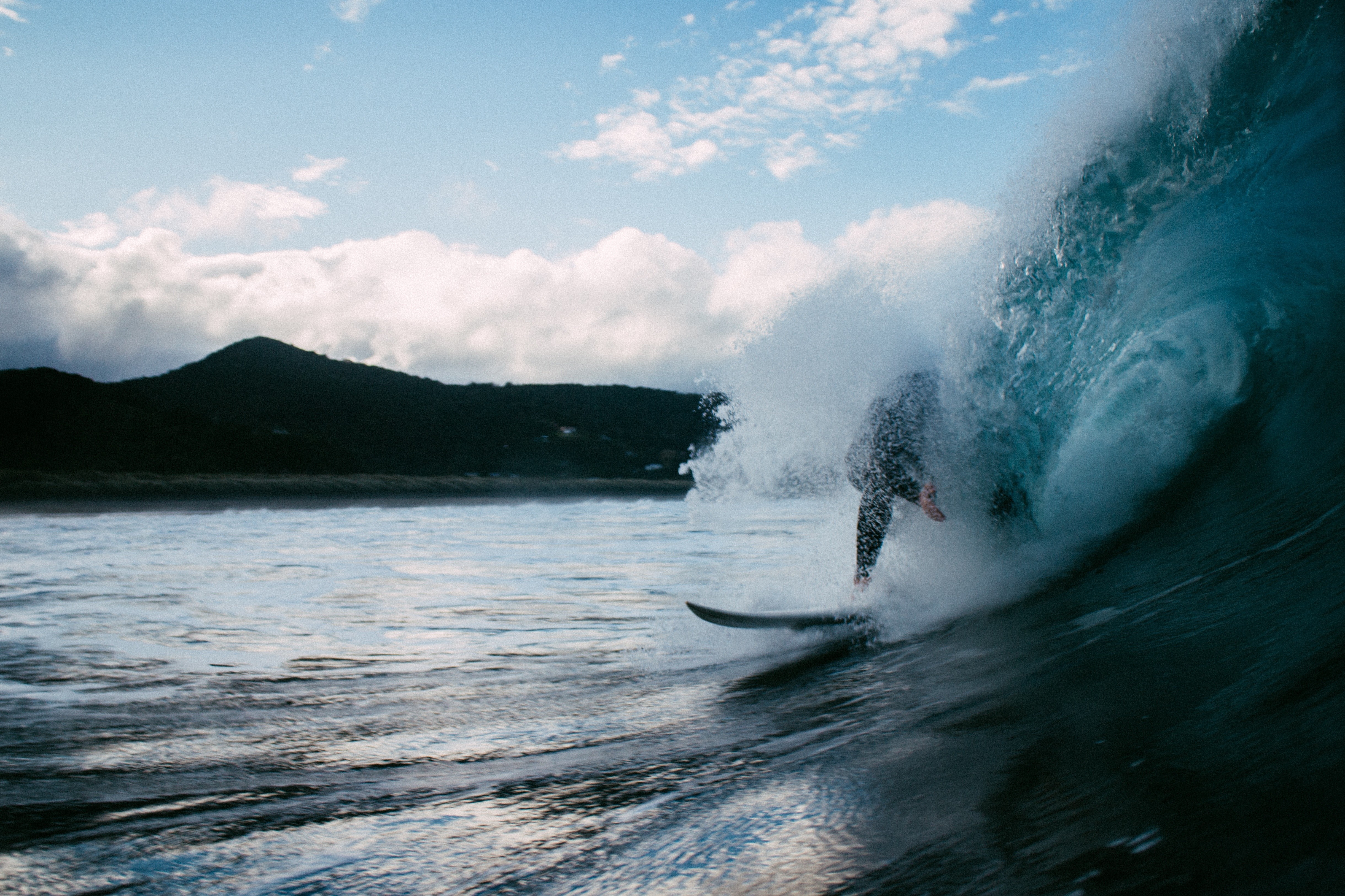 Surfer riding a wave in the ocean HD Wallpaper