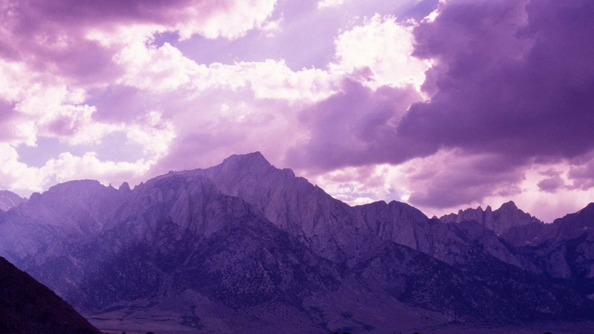 Purple mountain range under cloudy sky HD Wallpaper