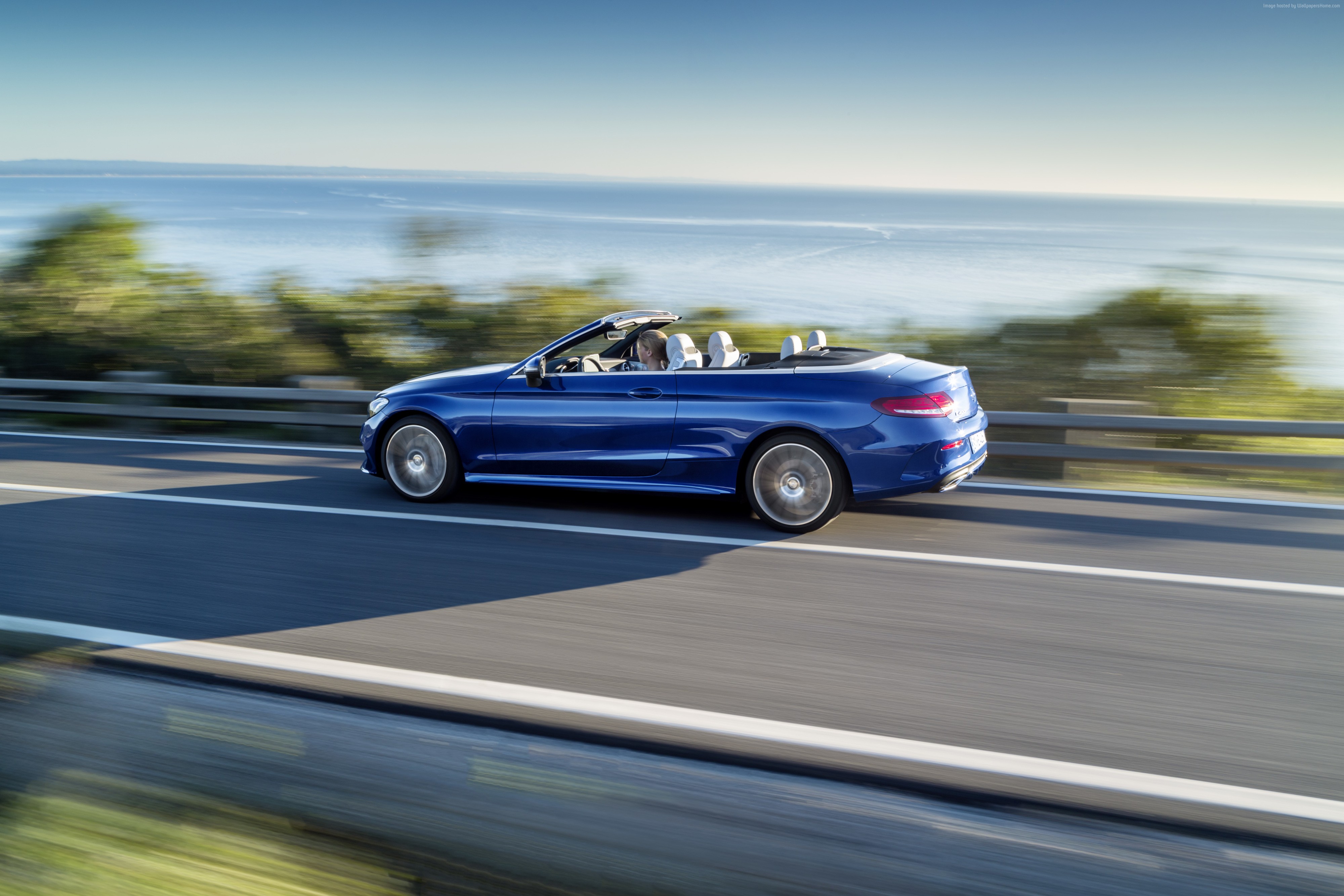 Blue Mercedes-Benz E400 Cabriolet driving on coastal road HD Wallpaper