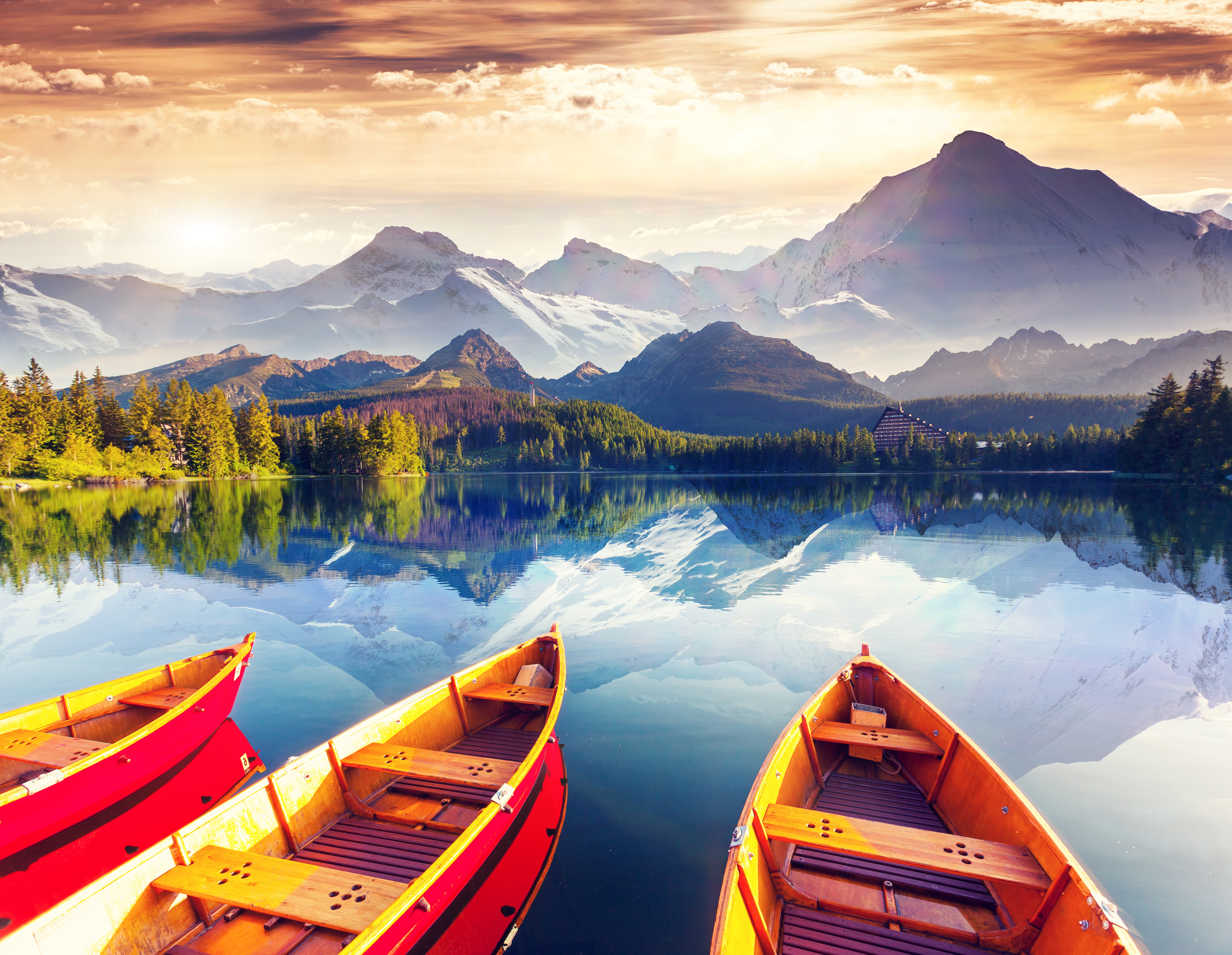 Boats on a lake with mountains and colorful sky HD Wallpaper