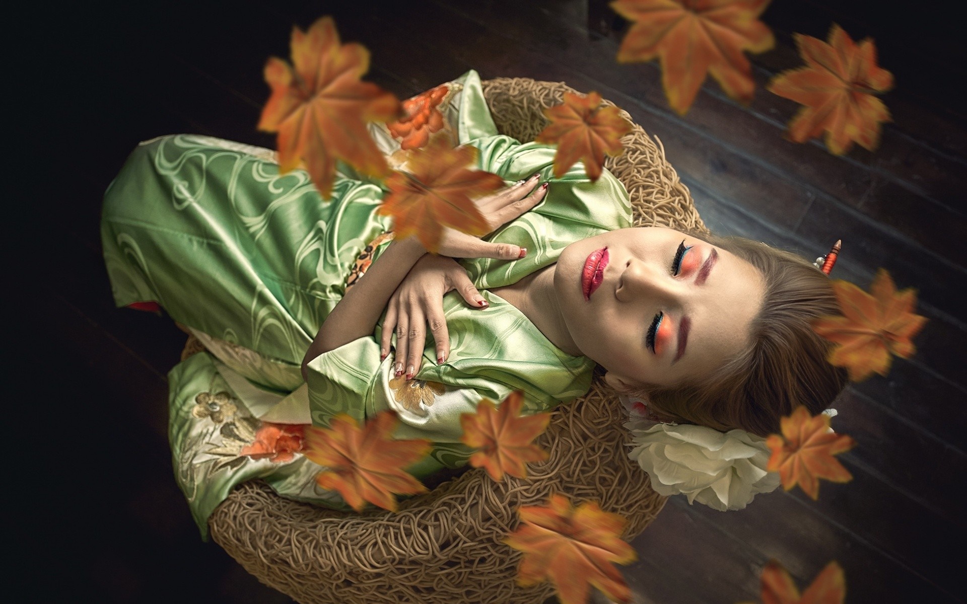 Woman in green kimono lying in a basket with autumn leaves HD Wallpaper