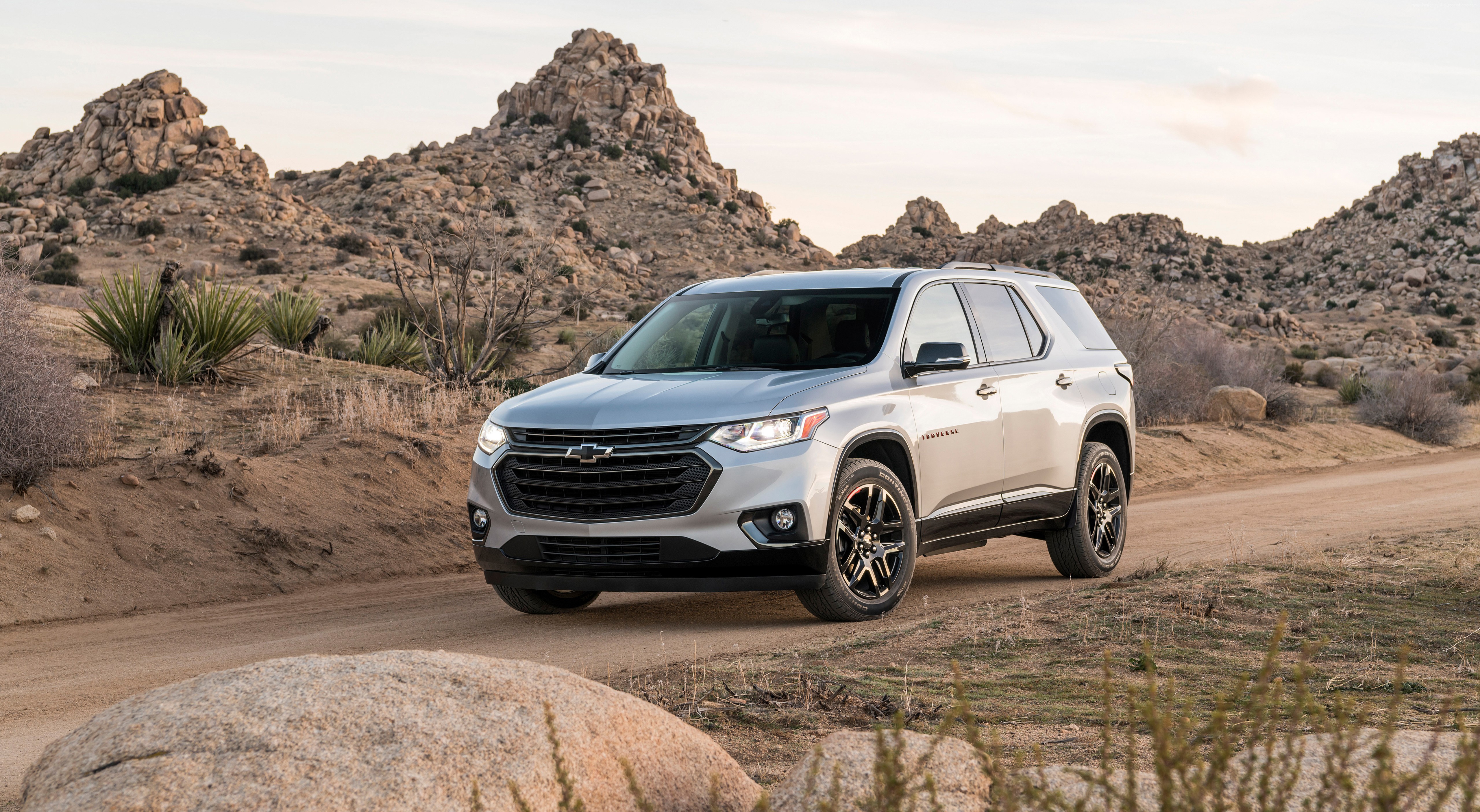 Silver Chevrolet Traverse SUV on a dirt road HD Wallpaper