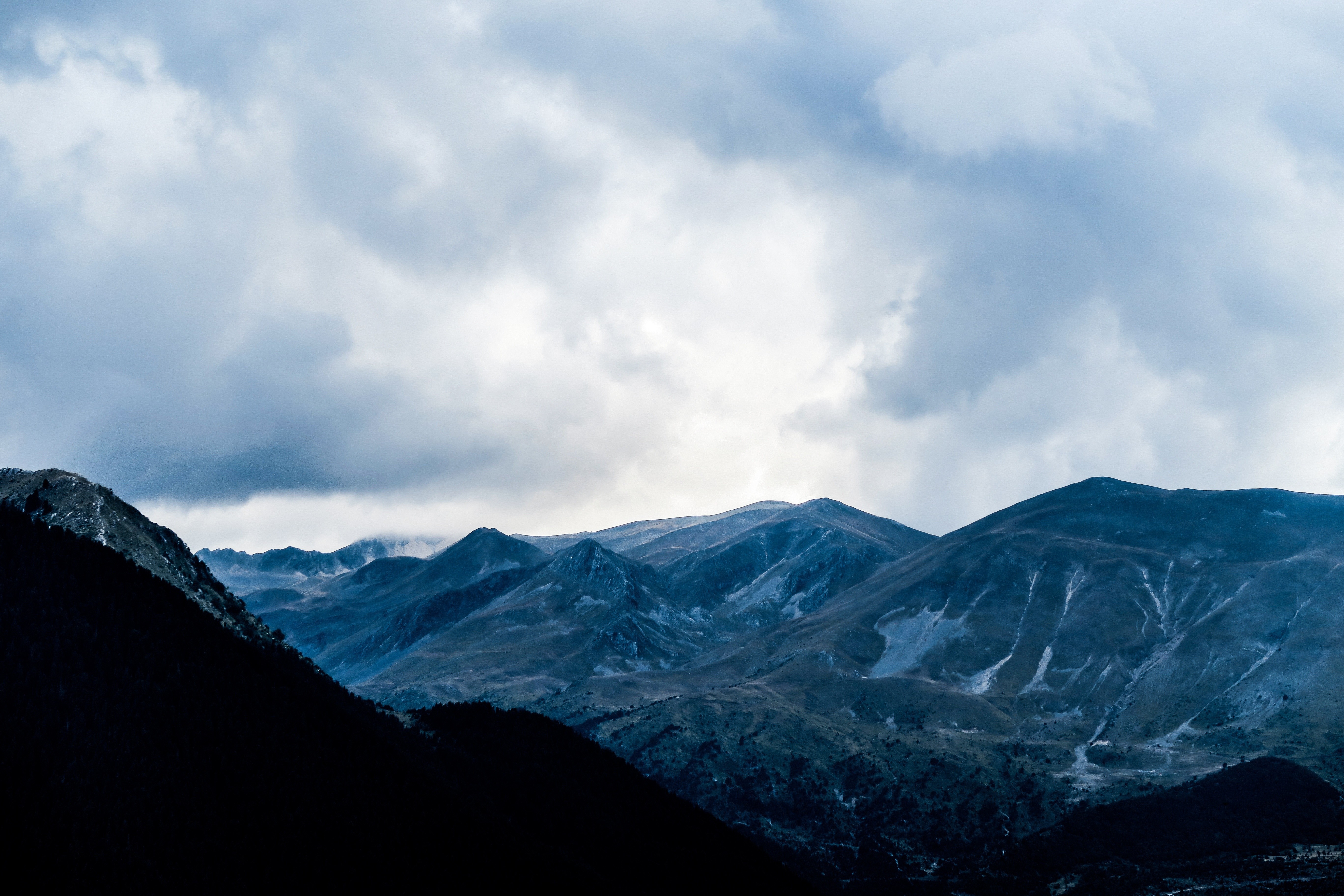 Dark Mountains Under Cloudy Sky HD Wallpaper