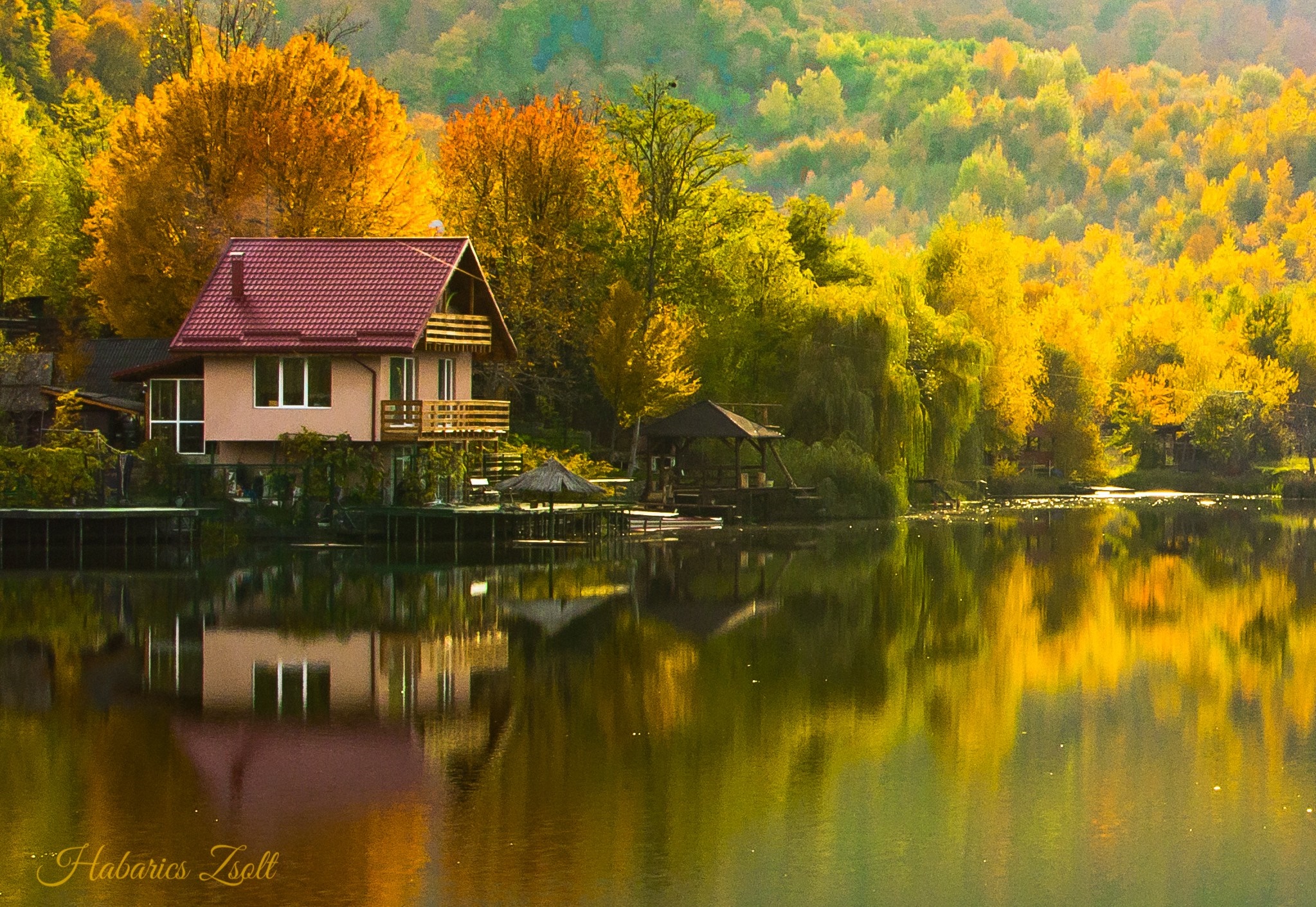 House on a lake during autumn with colorful trees HD Wallpaper