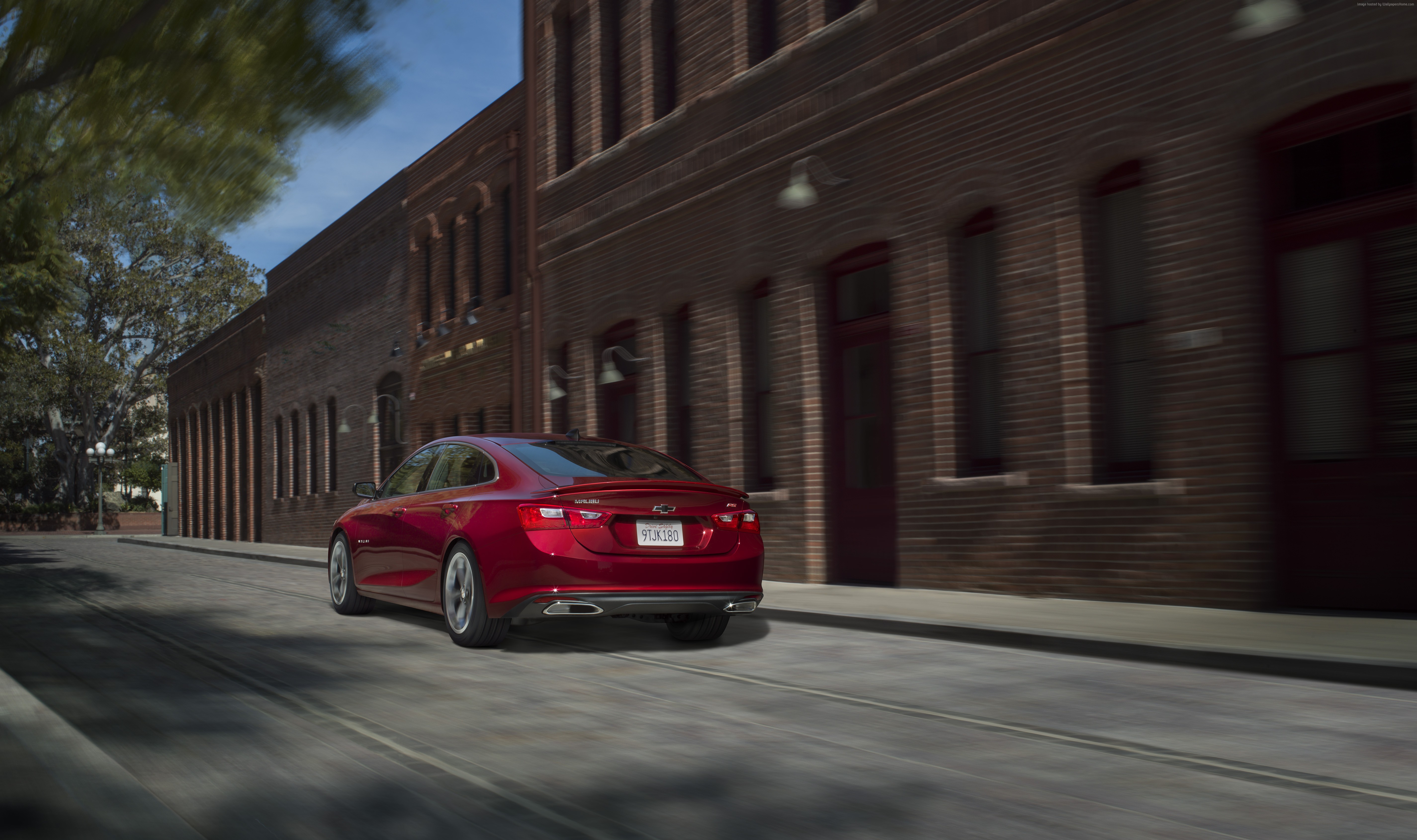 Red Chevrolet Malibu RS driving on a street HD Wallpaper