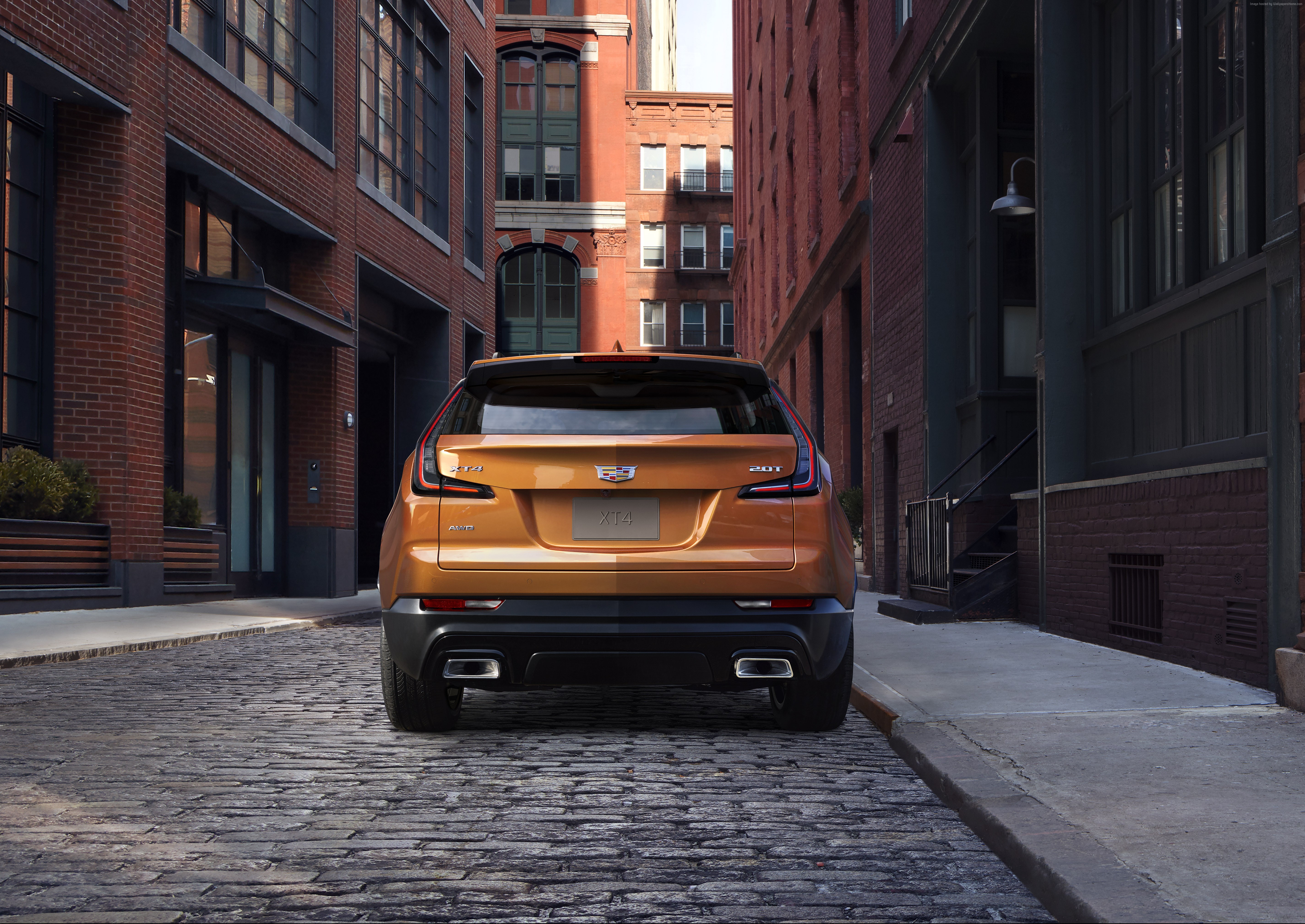 Cadillac XT4 parked on cobblestone street HD Wallpaper