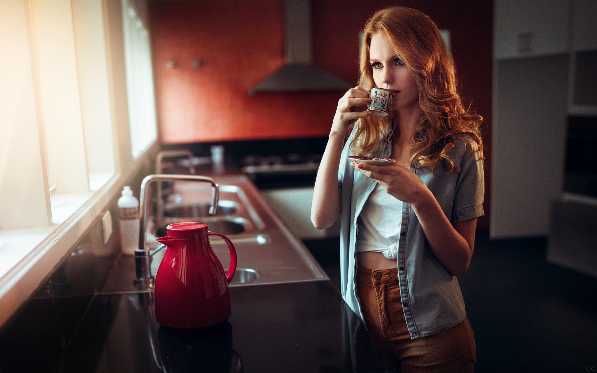 Redhead woman drinking coffee in a kitchen HD Wallpaper