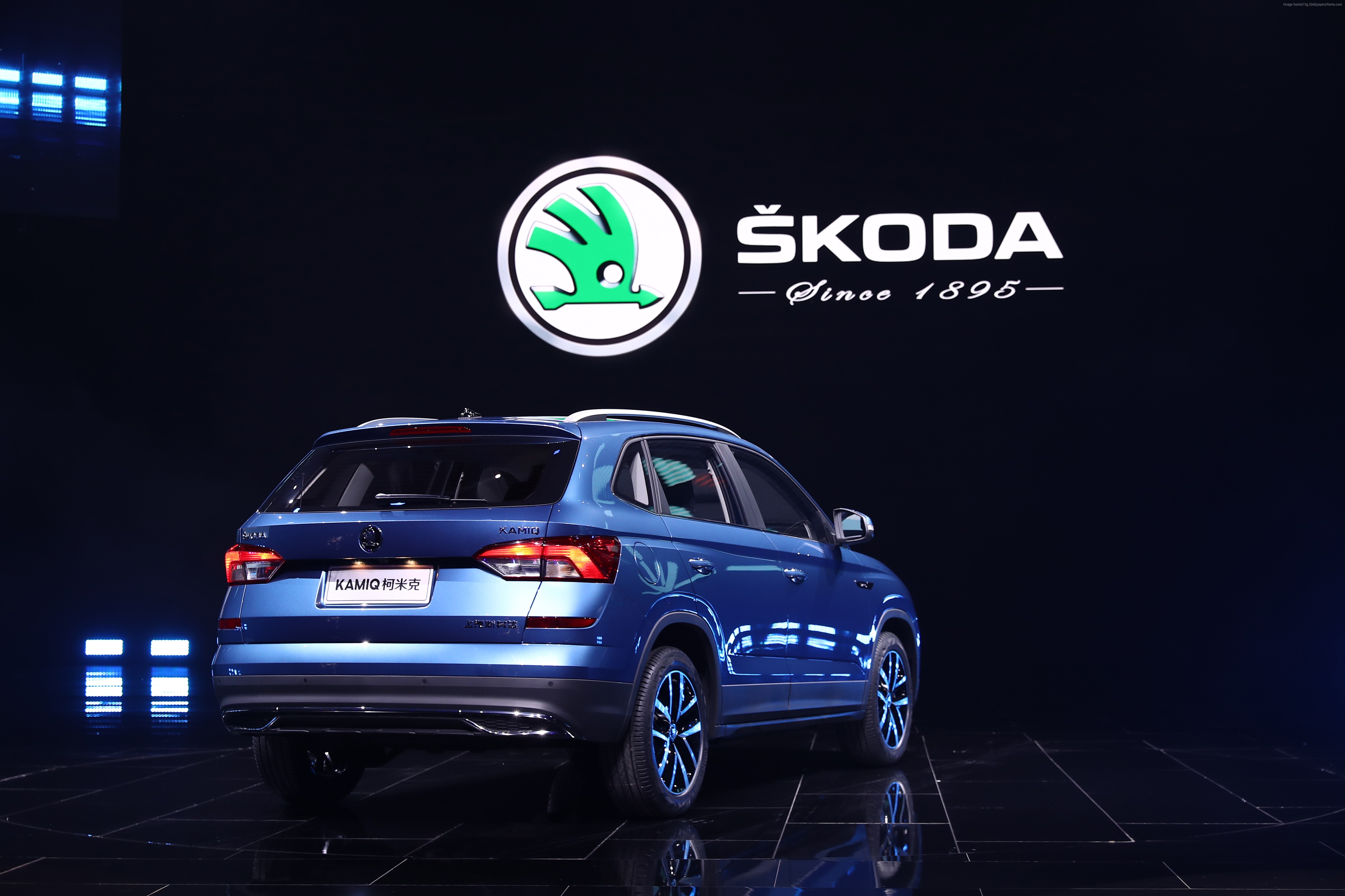 Skoda Kamiq SUV on display with Skoda logo HD Wallpaper