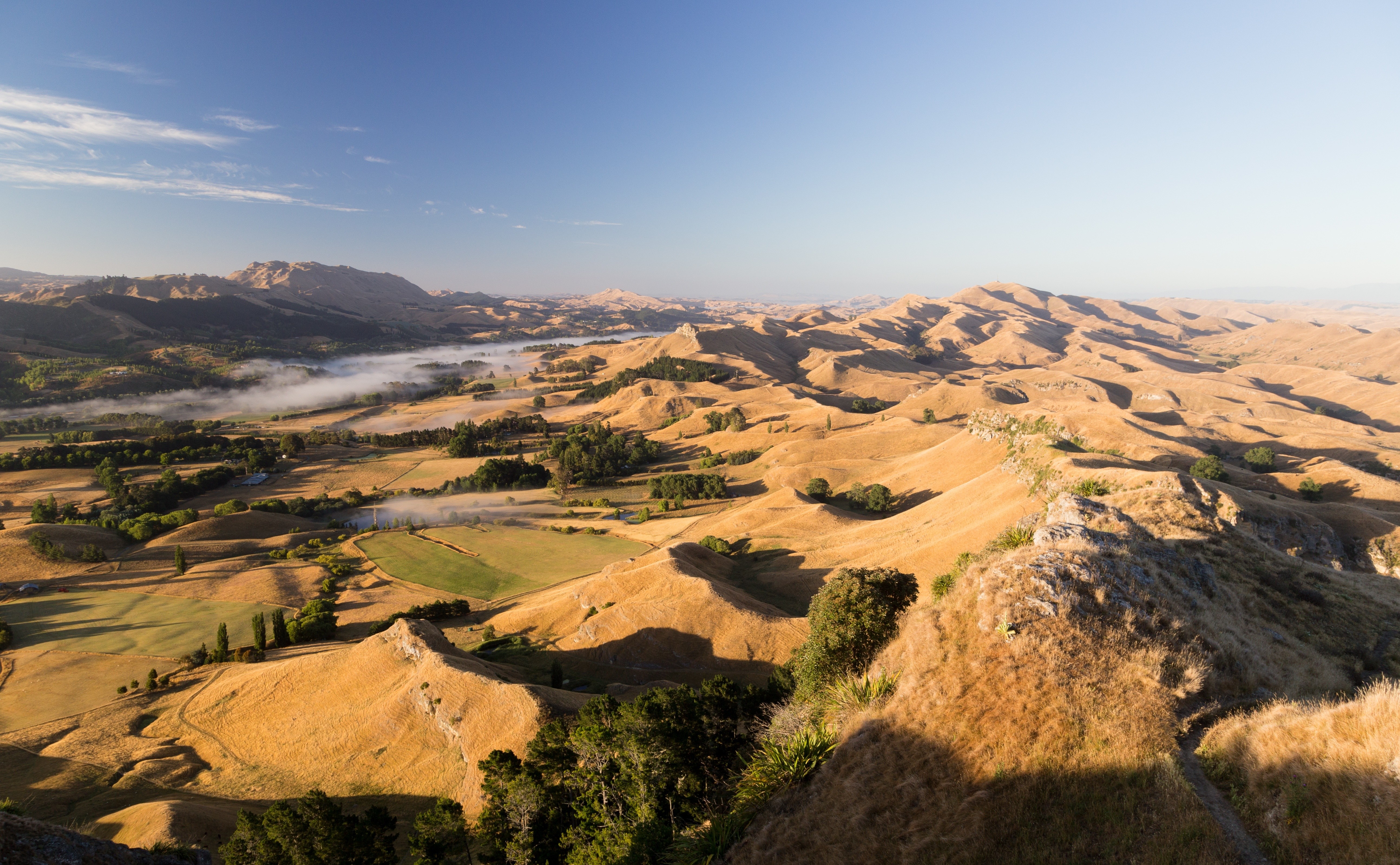 Golden hills and valleys under a clear blue sky HD Wallpaper