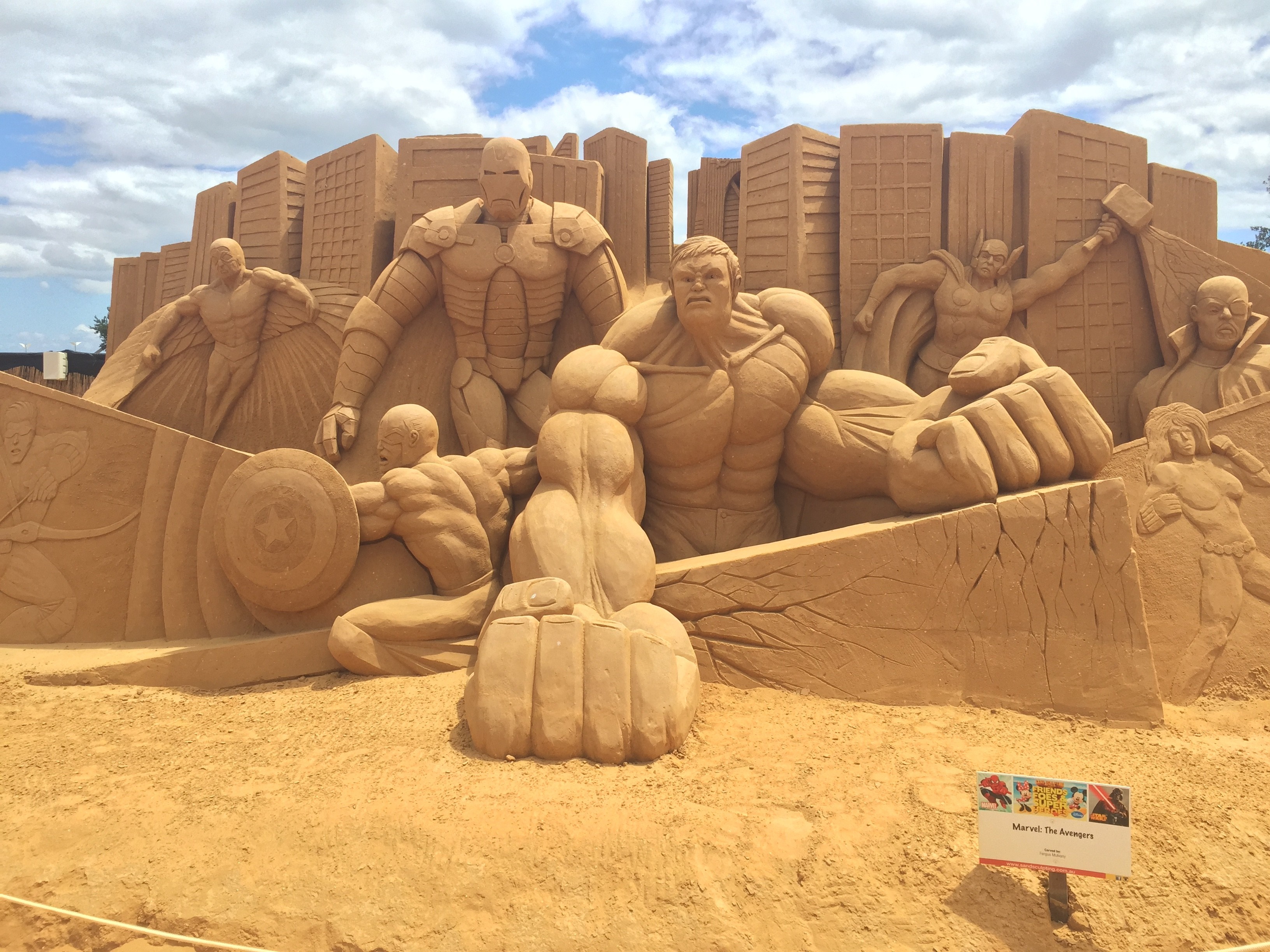 Sand Sculpture of The Avengers in a Cityscape HD Wallpaper