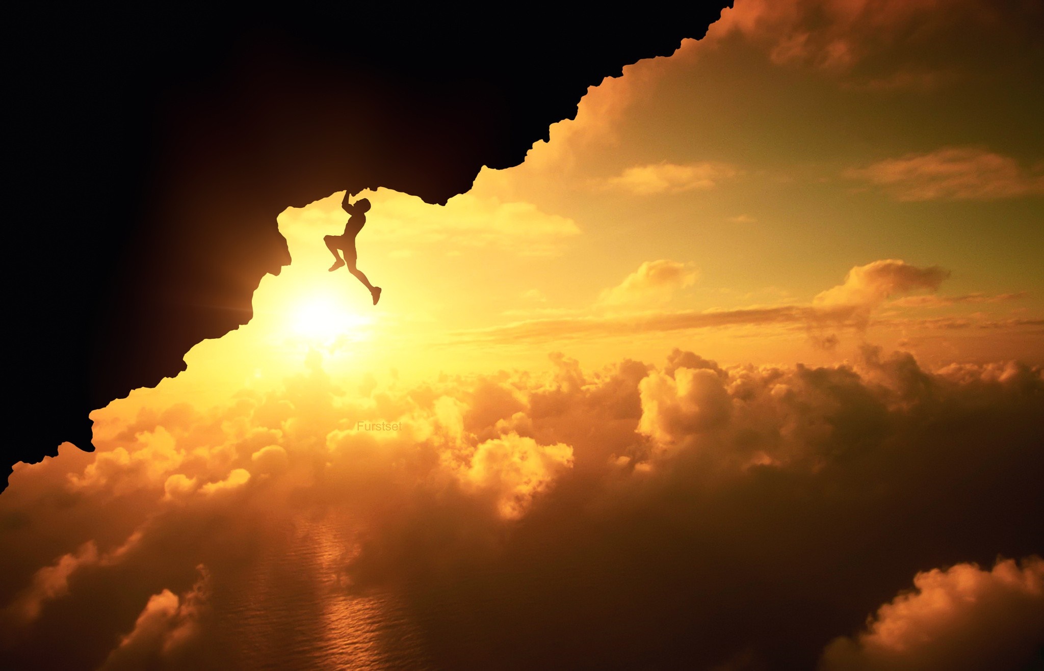 Silhouette of a climber hanging from a cliff at sunset HD Wallpaper