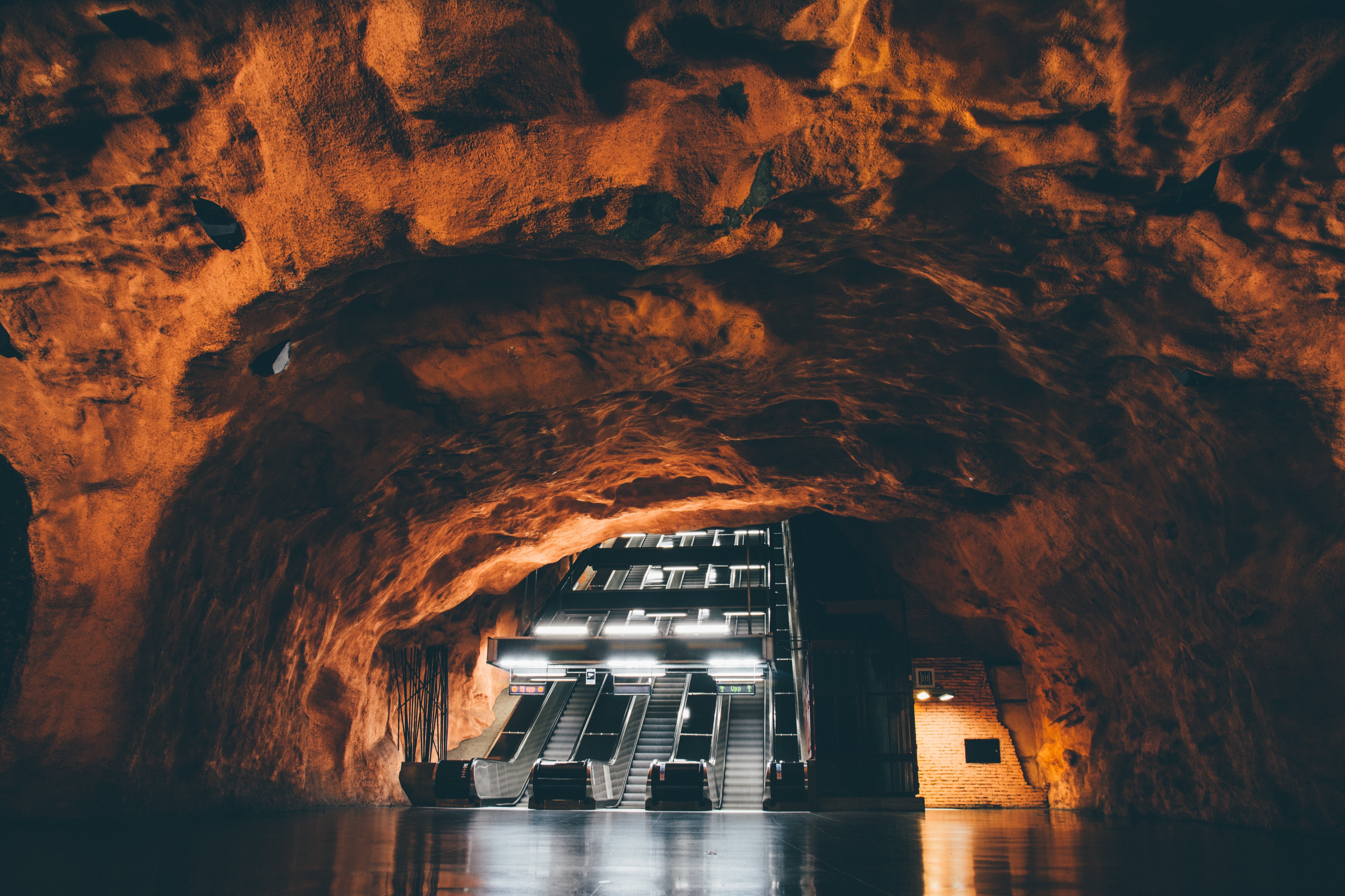 Escalators in a cave-like subway station HD Wallpaper
