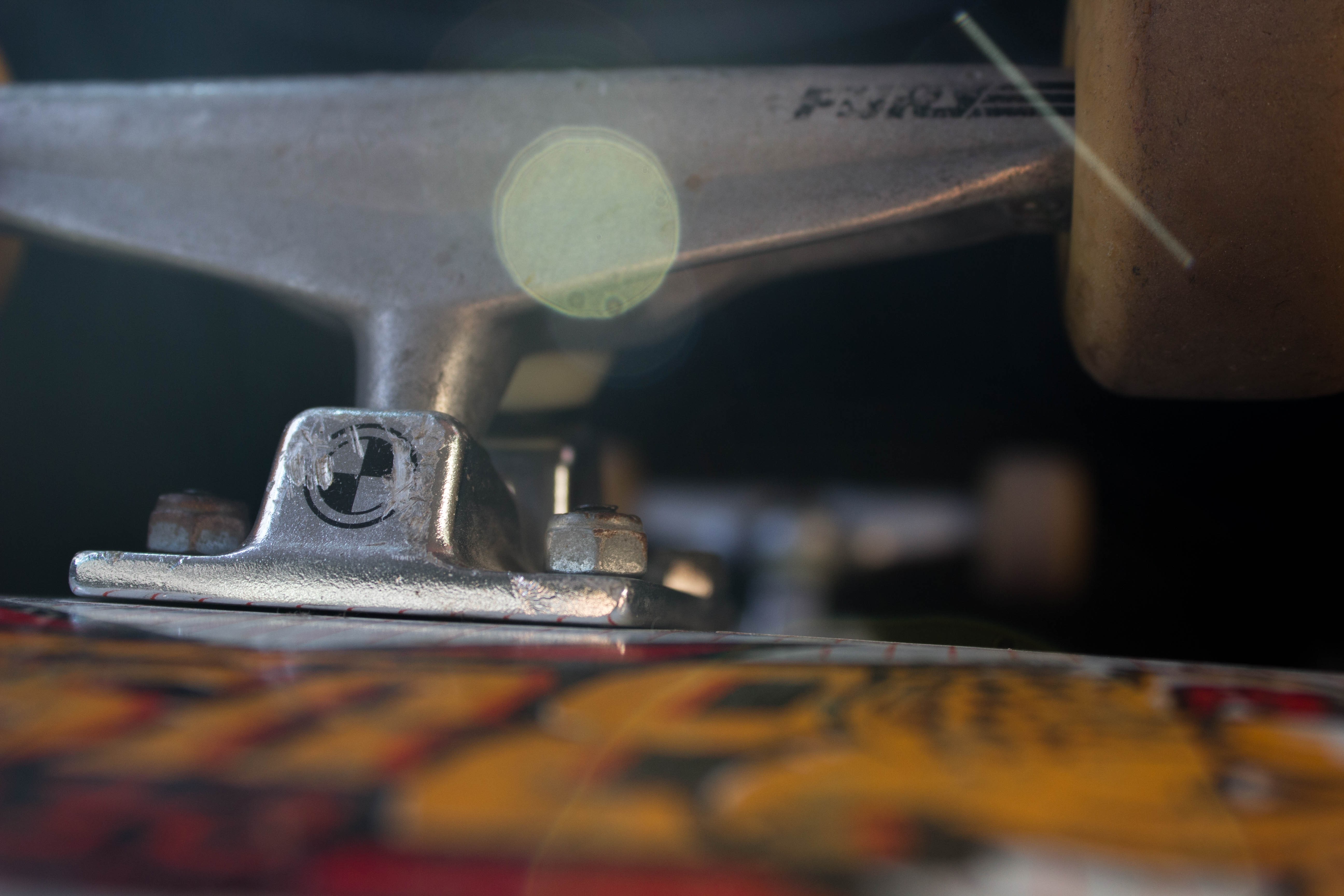 Close-up of a skateboard truck with logo HD Wallpaper