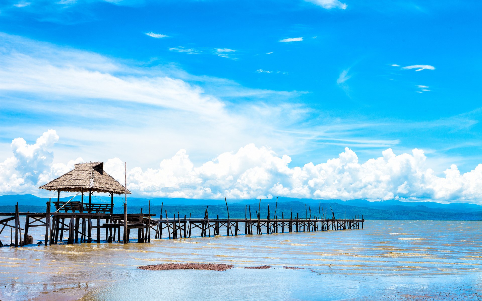 Wooden pier with thatched roof hut on a lake HD Wallpaper