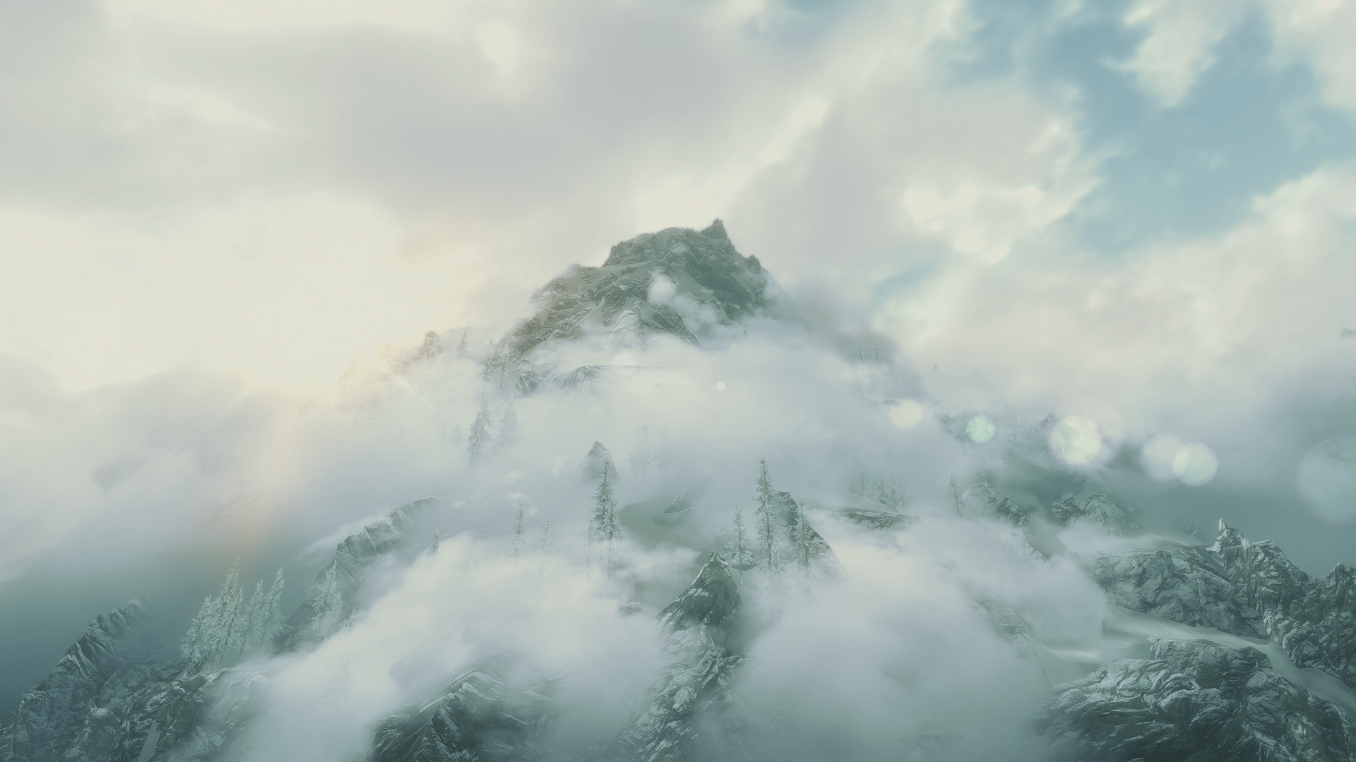 The Elder Scrolls V Skyrim mountain peak in mist and sunlight HD Wallpaper