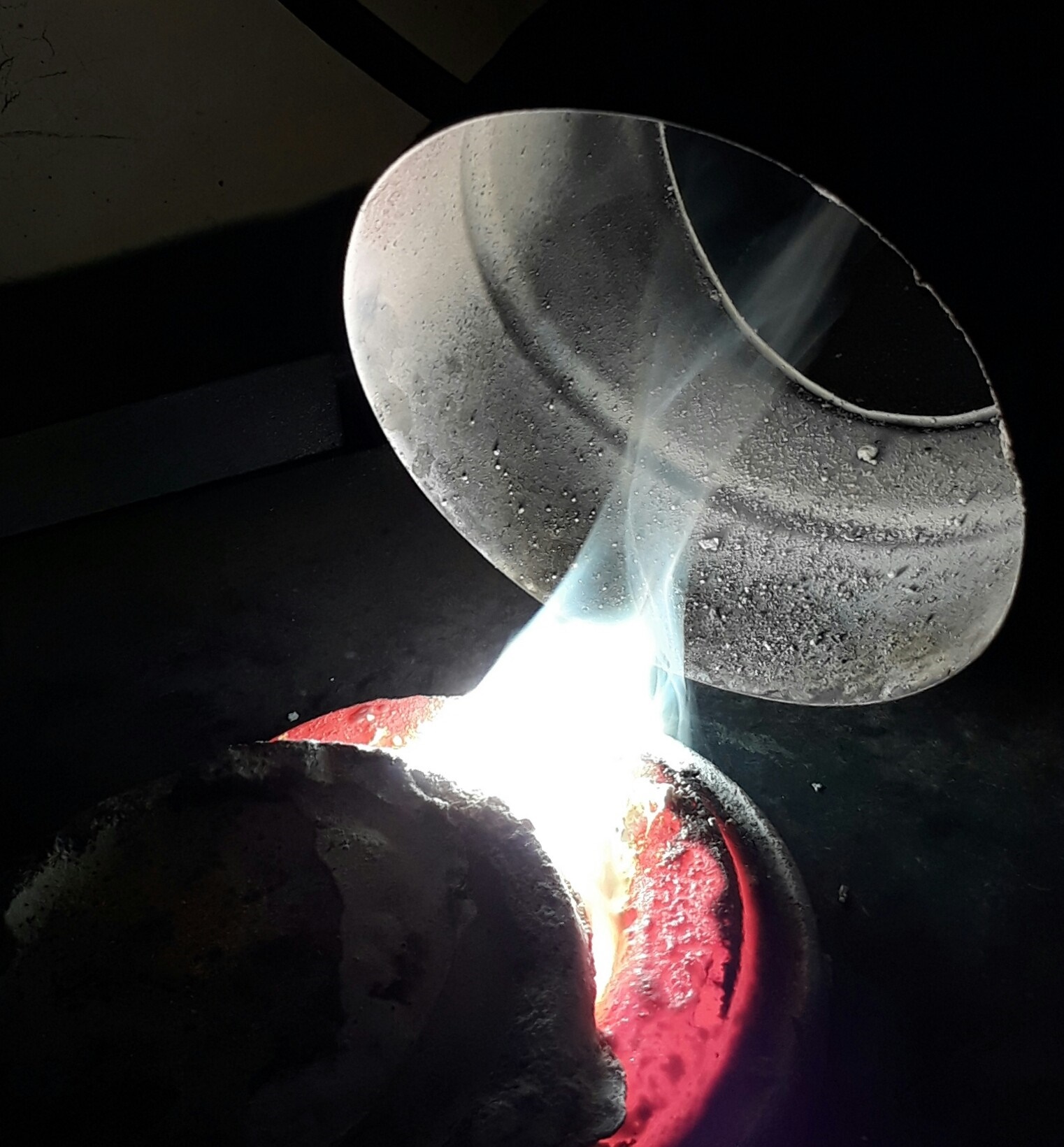 Molten metal being poured from a crucible HD Wallpaper