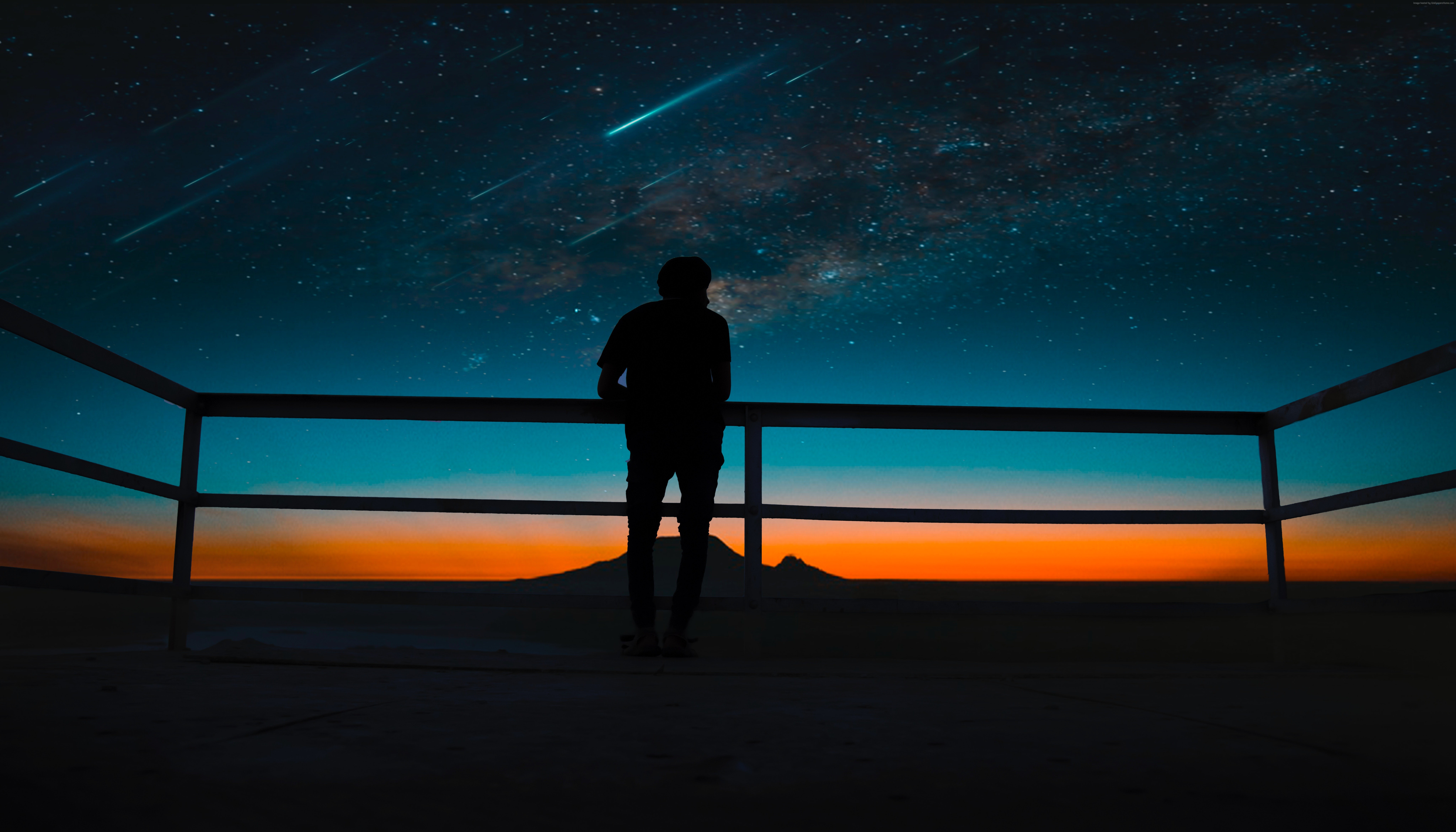 Silhouette of a person watching meteor shower HD Wallpaper