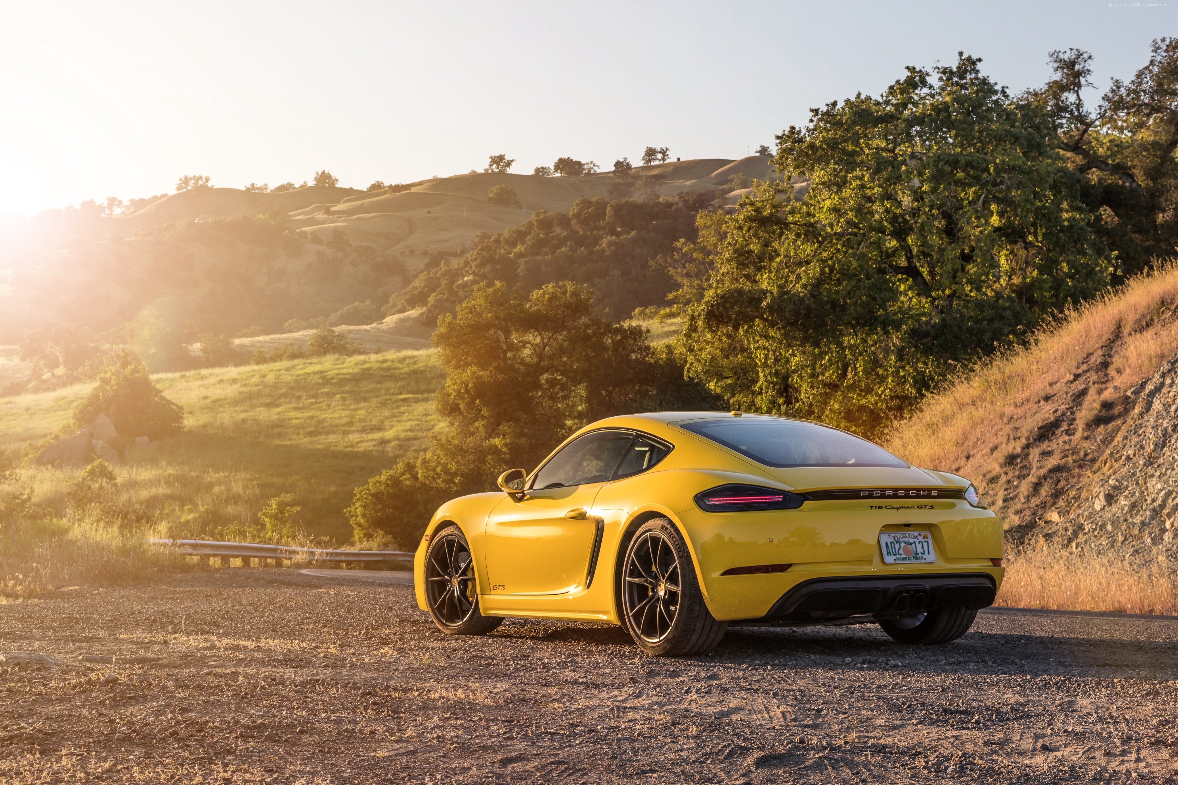 Yellow 2019 Porsche 718 Cayman GTS on a dirt road HD Wallpaper