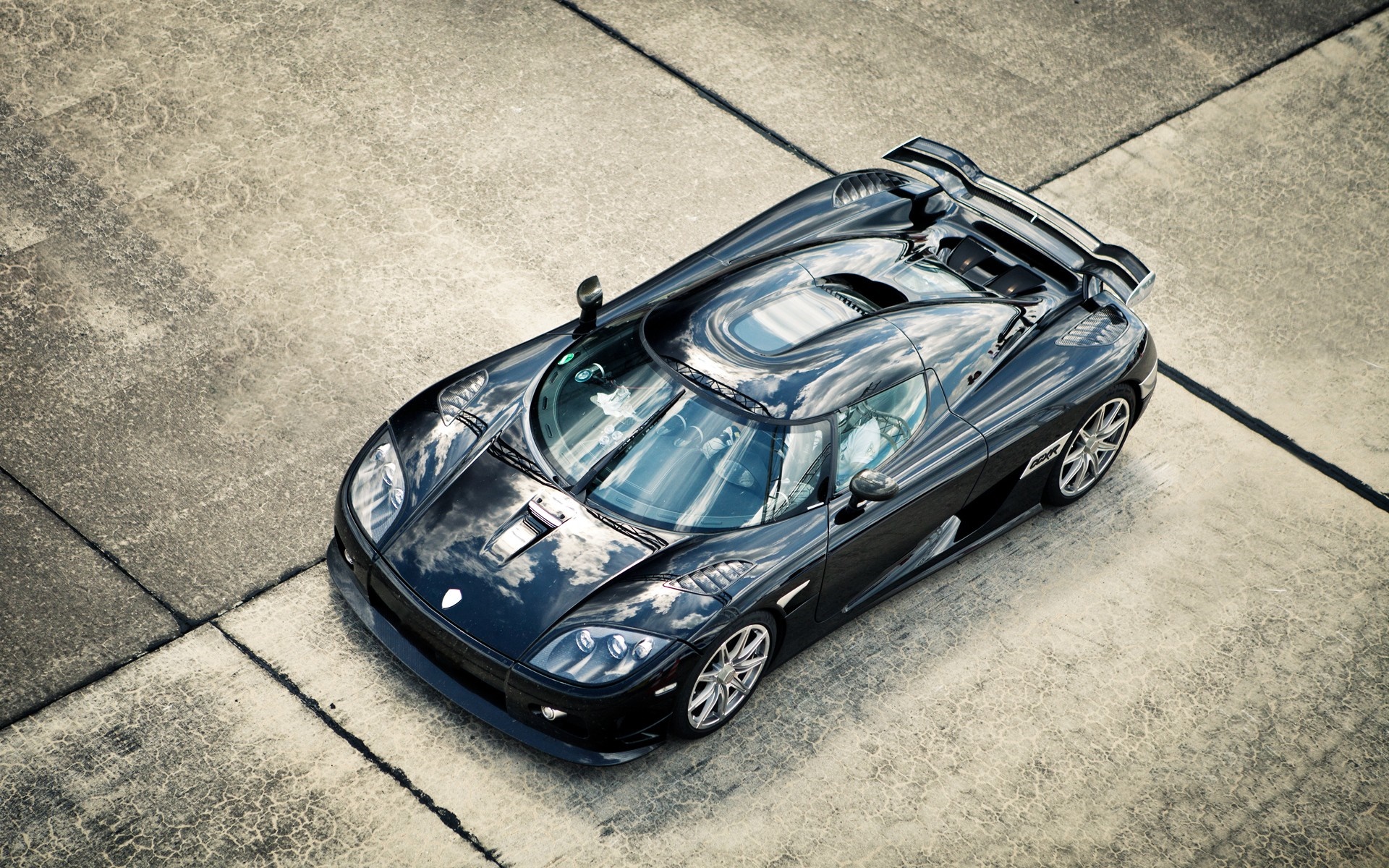 Black Koenigsegg supercar on concrete HD Wallpaper