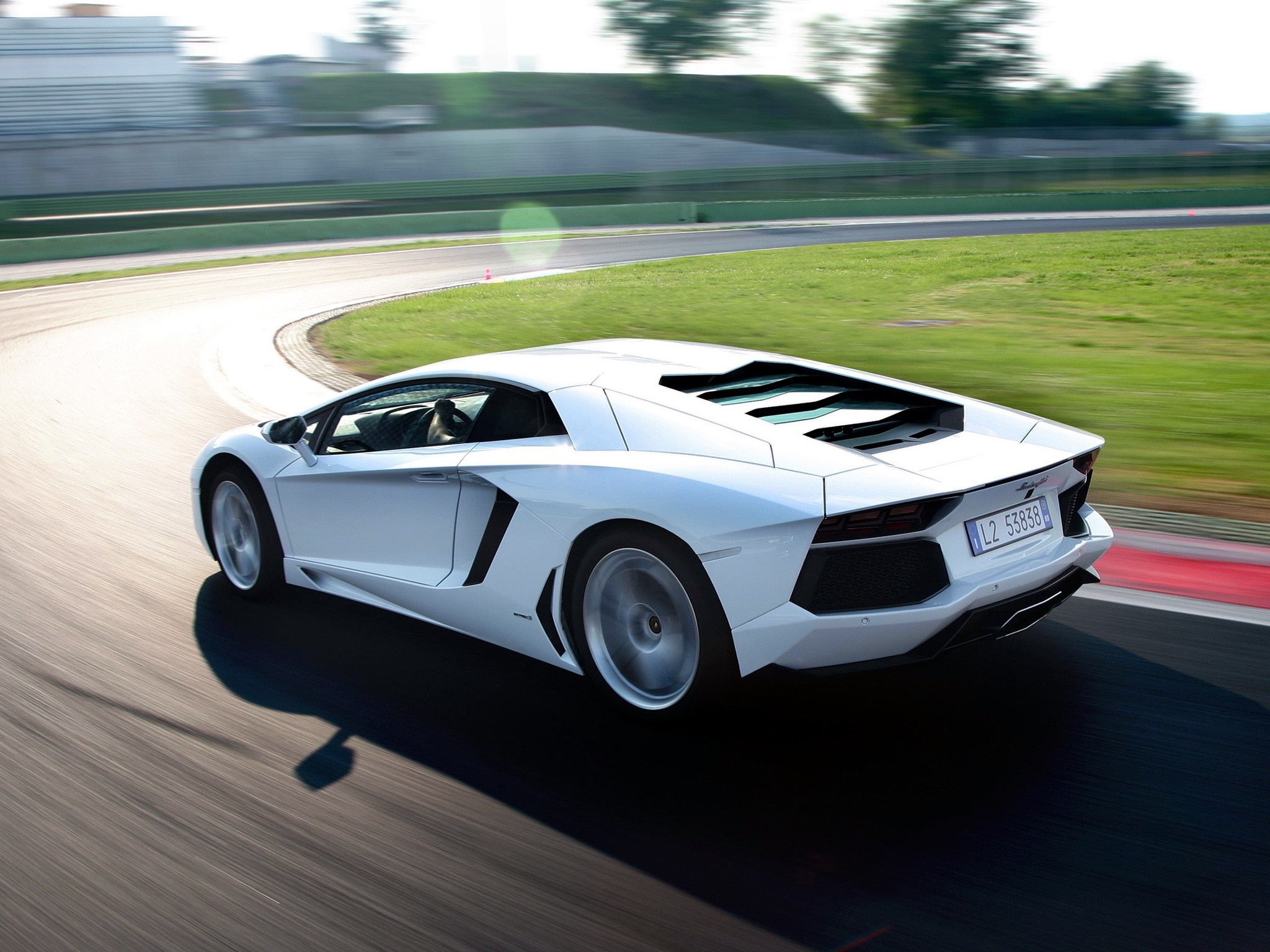 White Lamborghini Aventador driving on a race track HD Wallpaper
