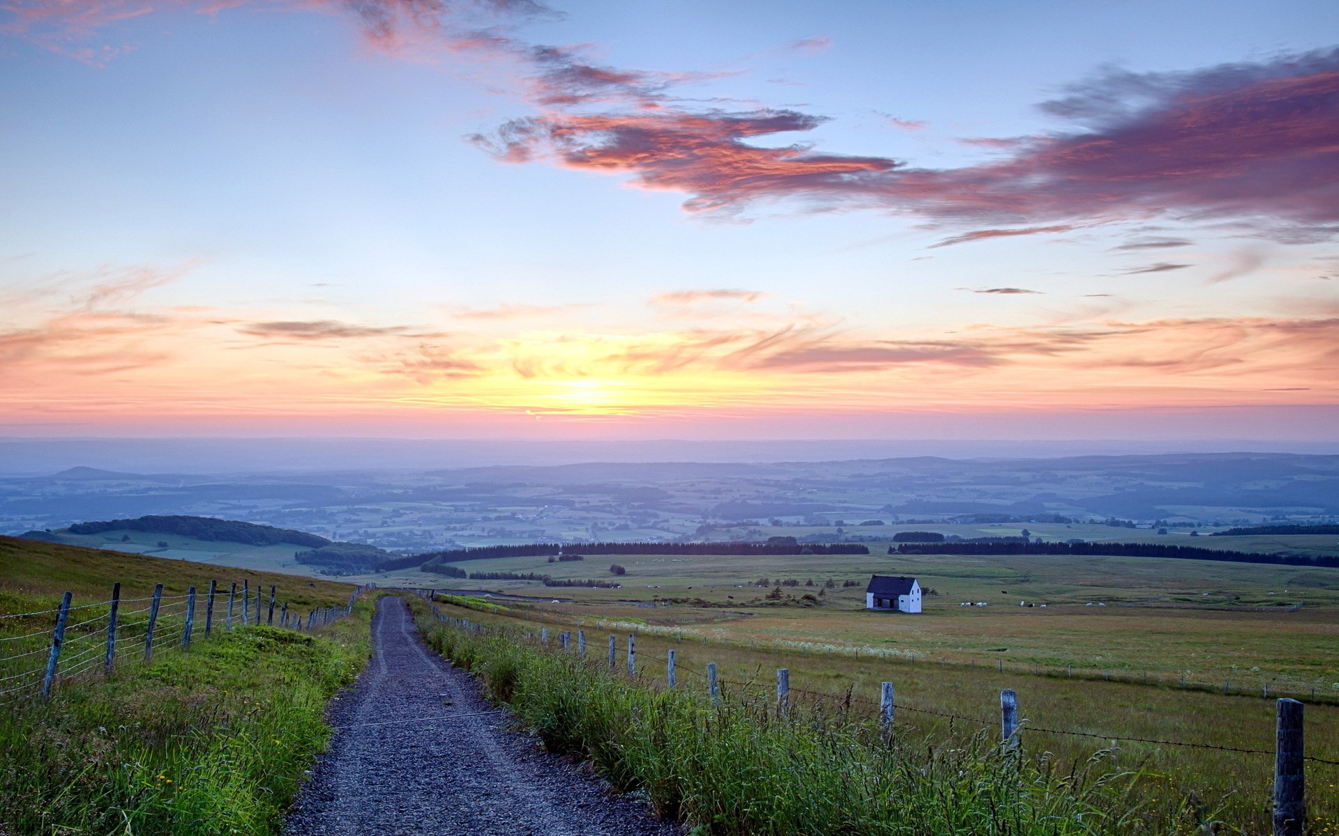 Rural landscape at sunrise with a dirt path and a house HD Wallpaper