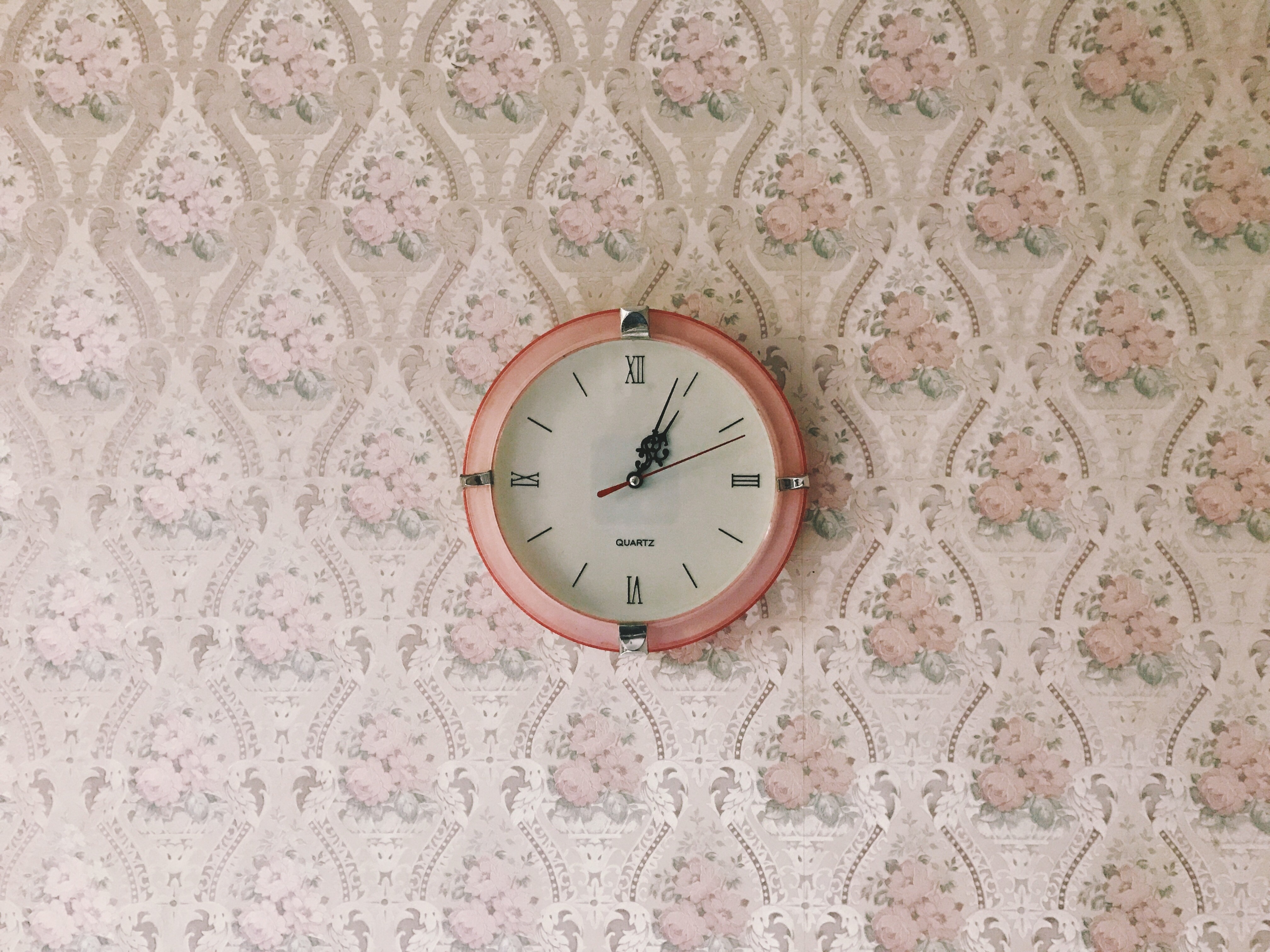 Pink analog clock on floral wallpaper HD Wallpaper