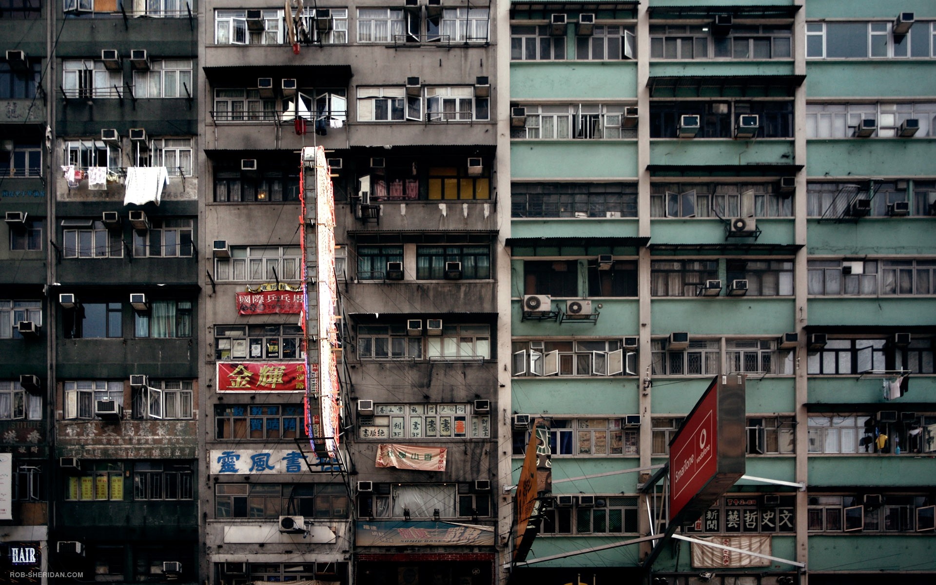 Dense urban apartment buildings with many windows and air conditioners HD Wallpaper