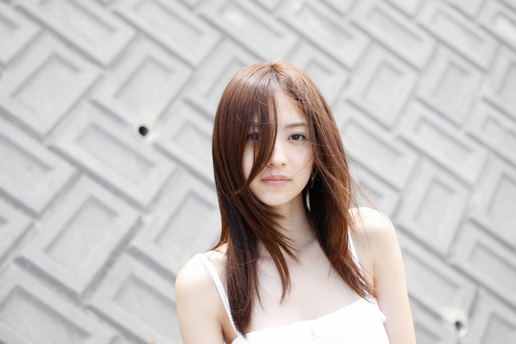 Serene Portrait of a Woman with Long Brown Hair HD Wallpaper