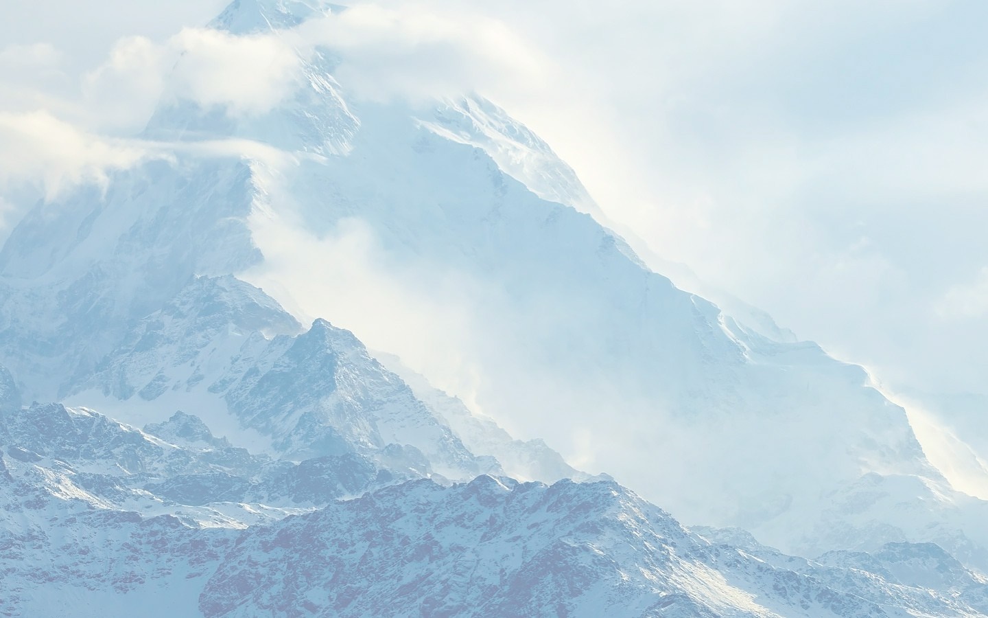 Snow-covered mountains shrouded in clouds HD Wallpaper