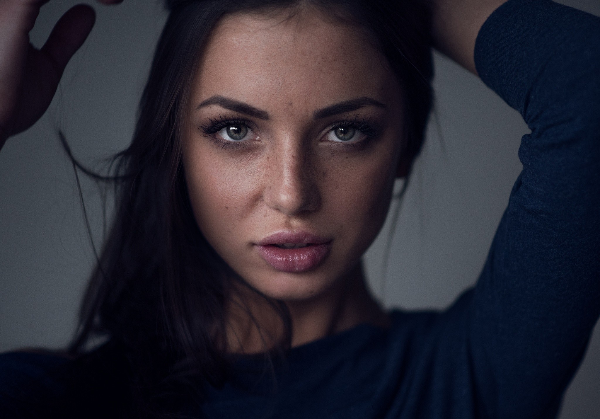 Woman with freckles and dark hair posing HD Wallpaper