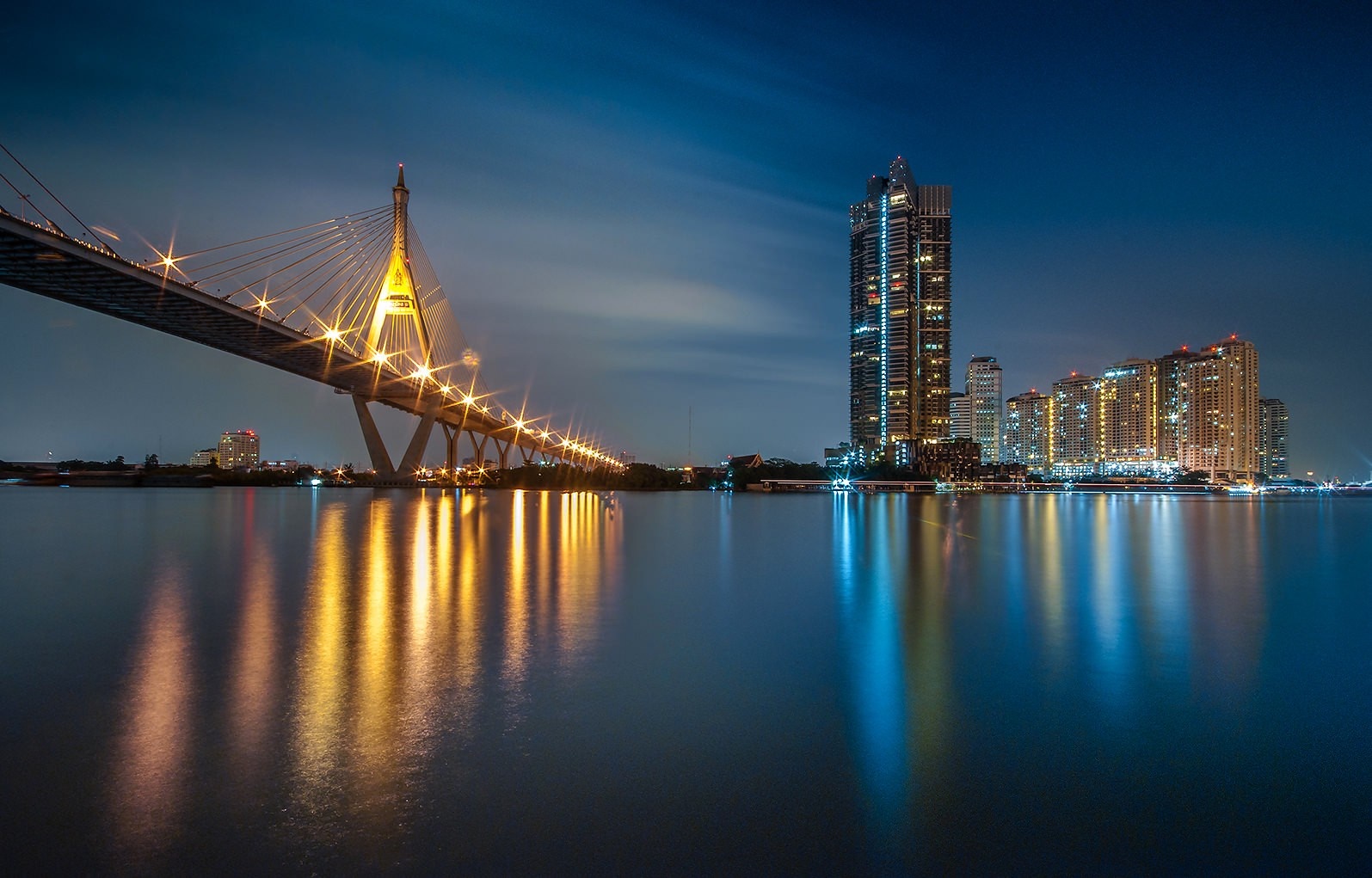 Night cityscape with illuminated Bhumibol Bridge and skyscrapers over water HD Wallpaper
