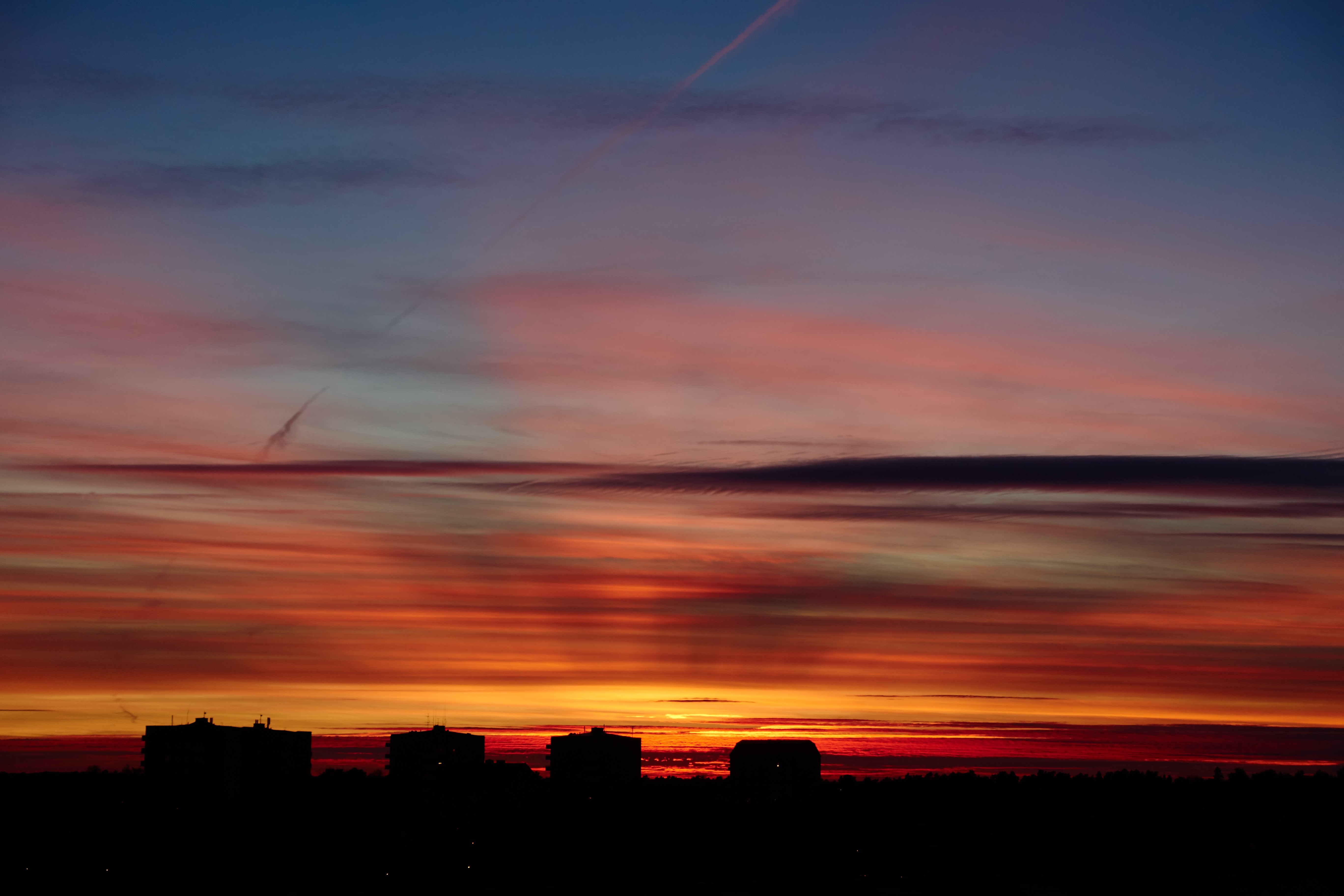 Silhouette of buildings against a colorful sunset sky HD Wallpaper