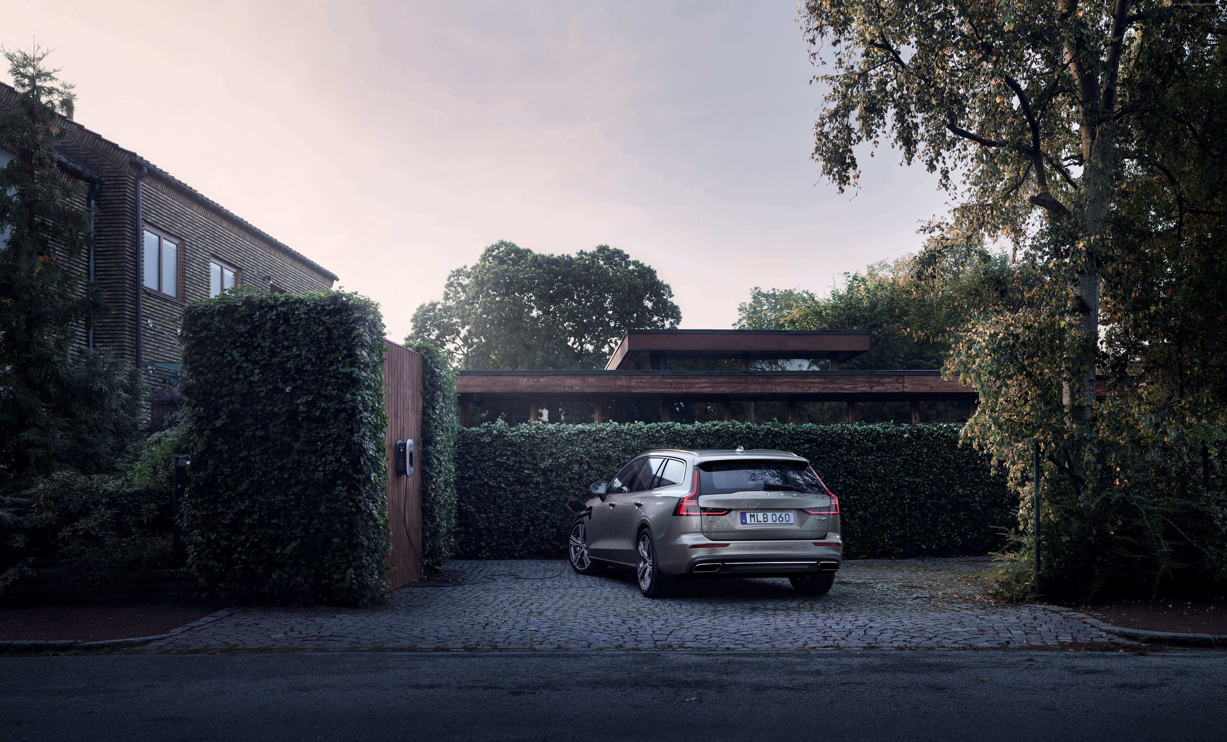 Volvo V60 parked in driveway near modern house HD Wallpaper