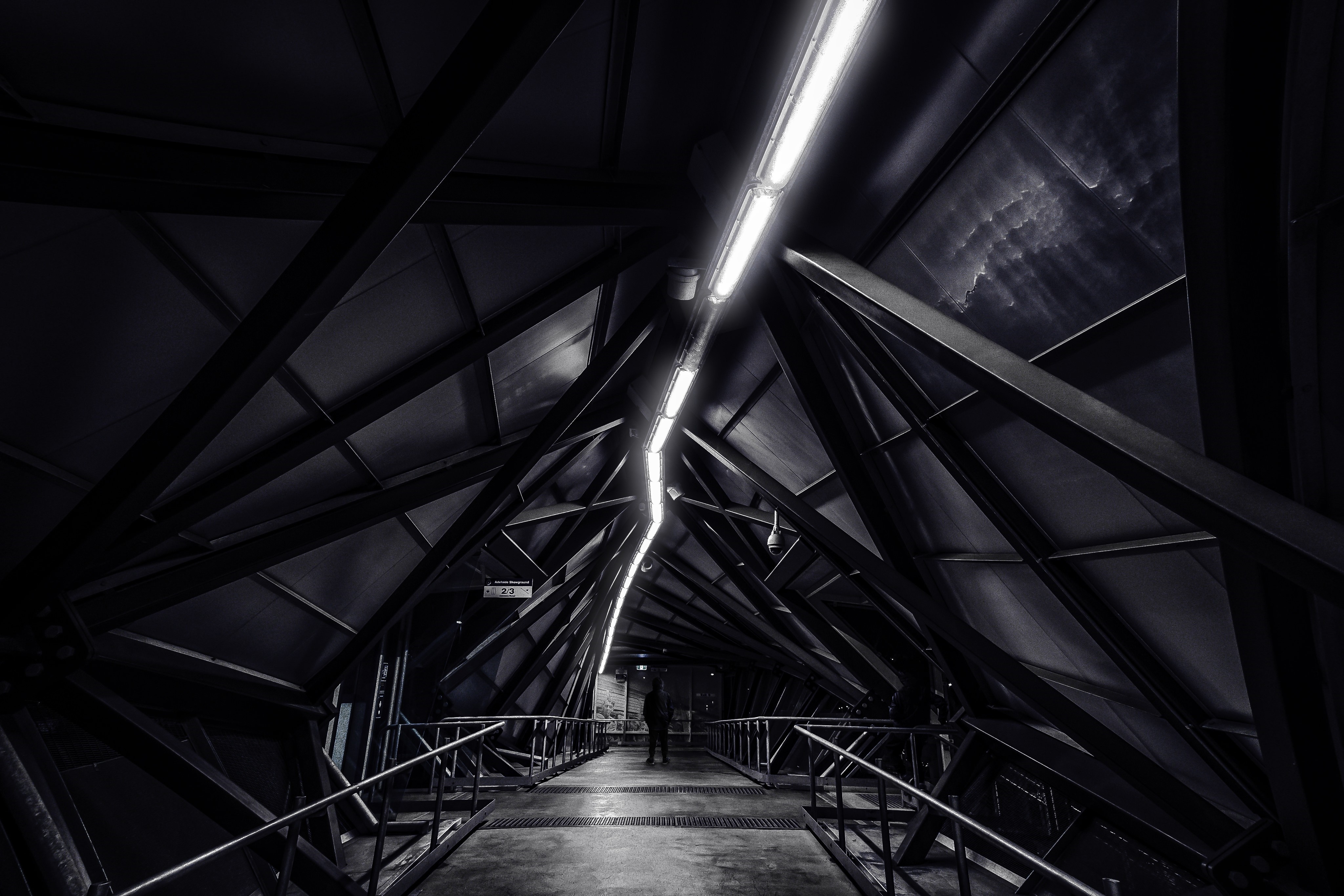 Monochrome architectural walkway with overhead lighting HD Wallpaper