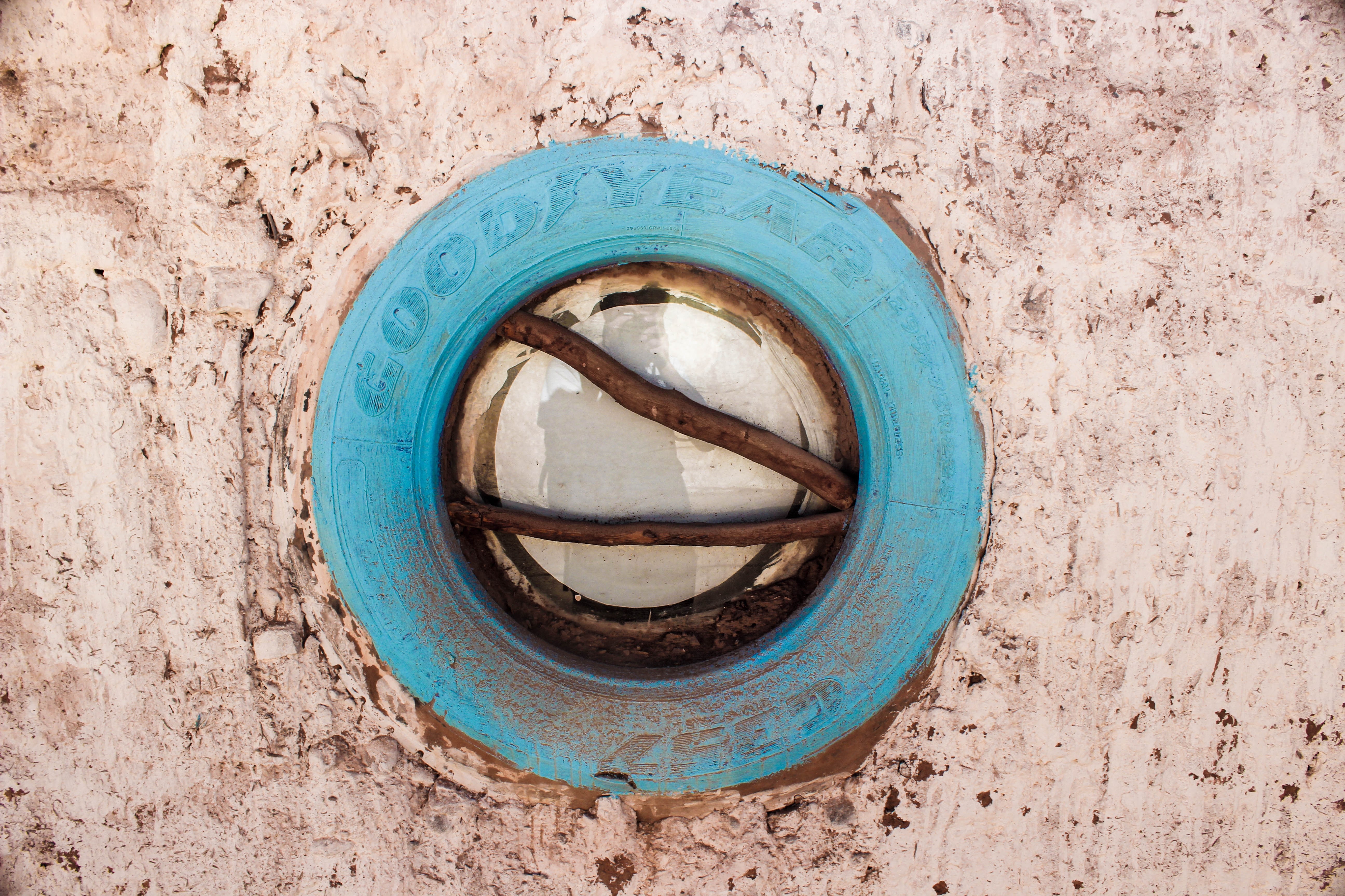 Blue Goodyear tire used as a window frame HD Wallpaper