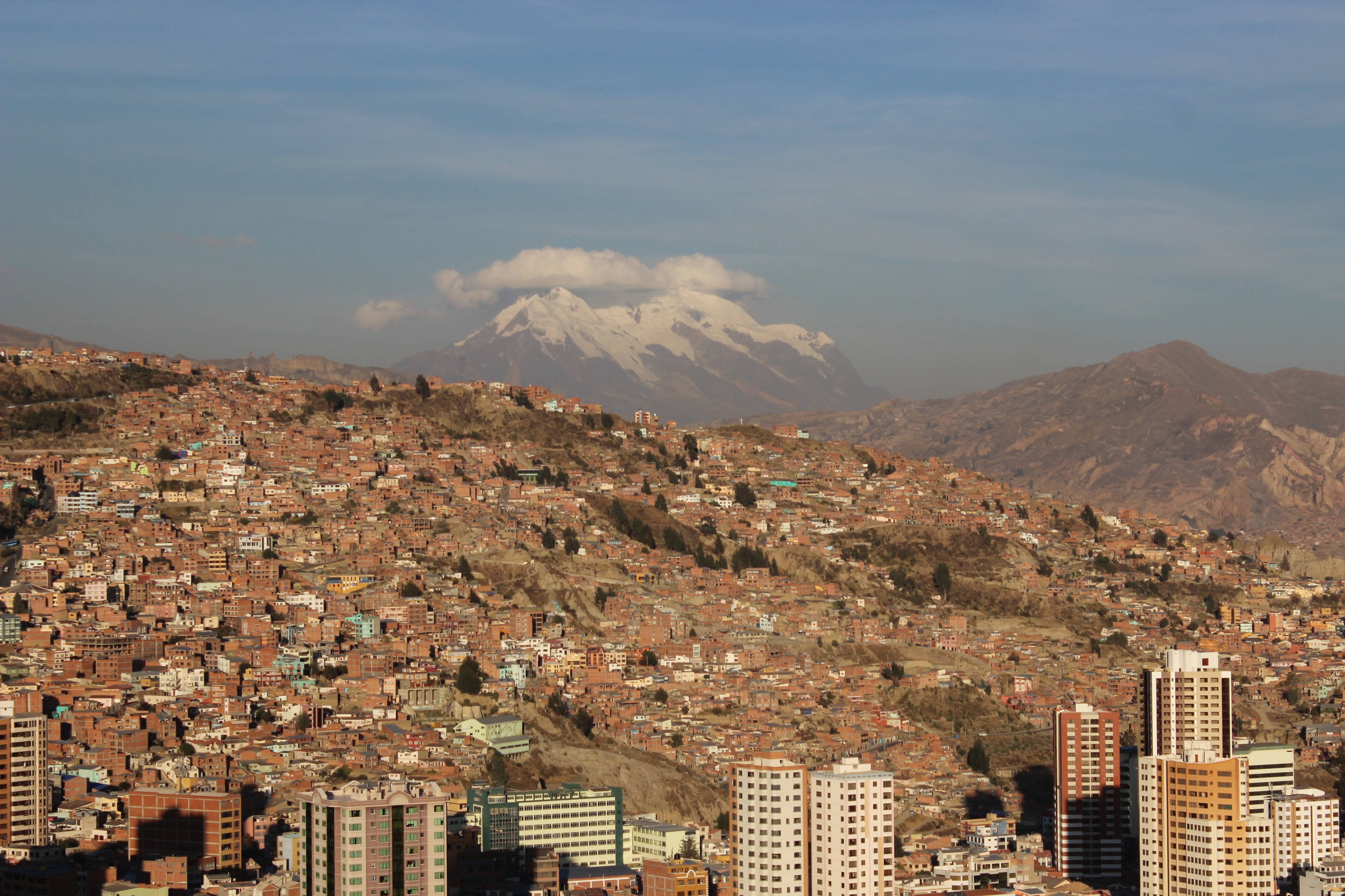 Cityscape of La Paz, Bolivia with snow-capped mountains in the background HD Wallpaper