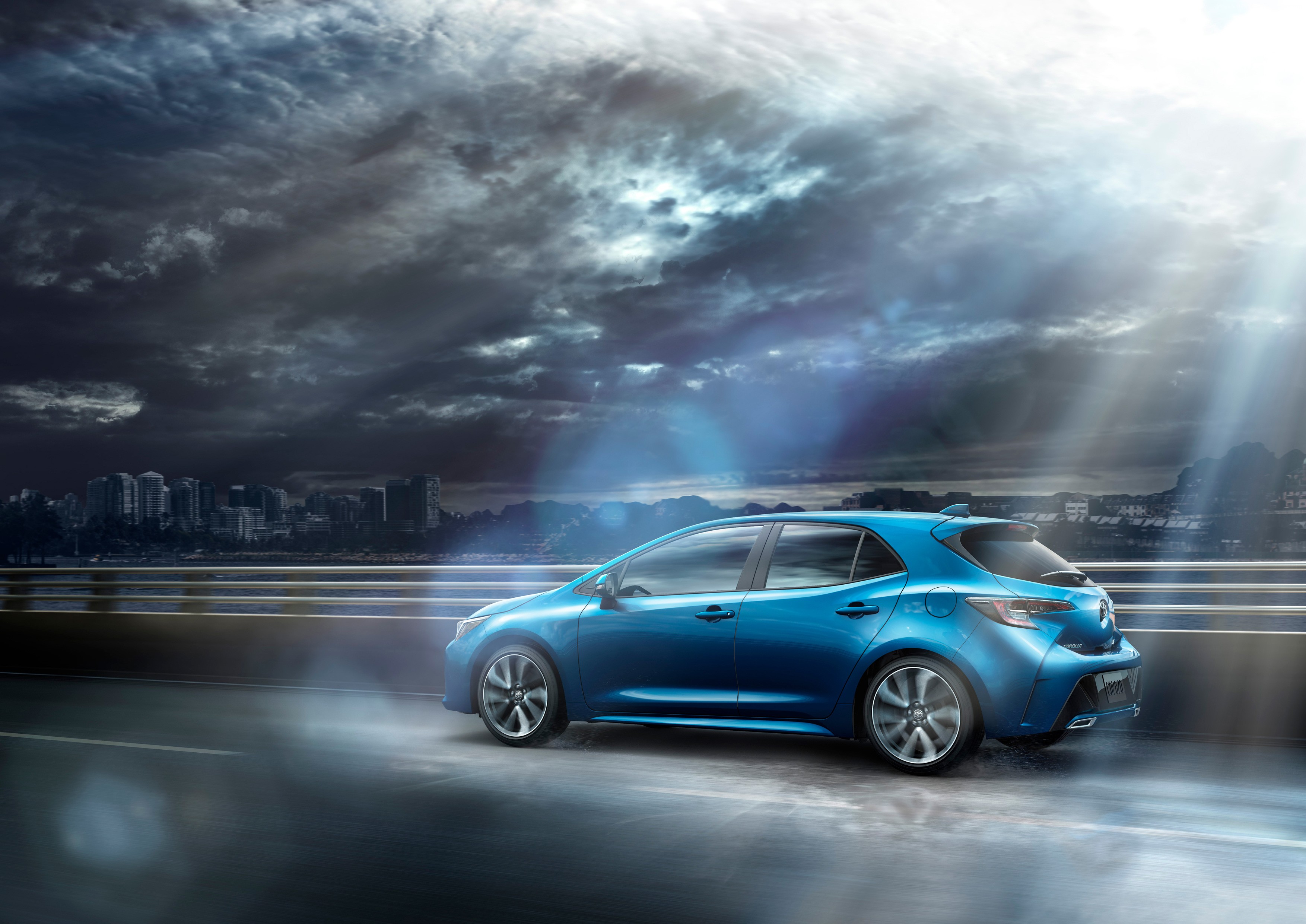 2019 Toyota Corolla Hatchback on a wet road HD Wallpaper