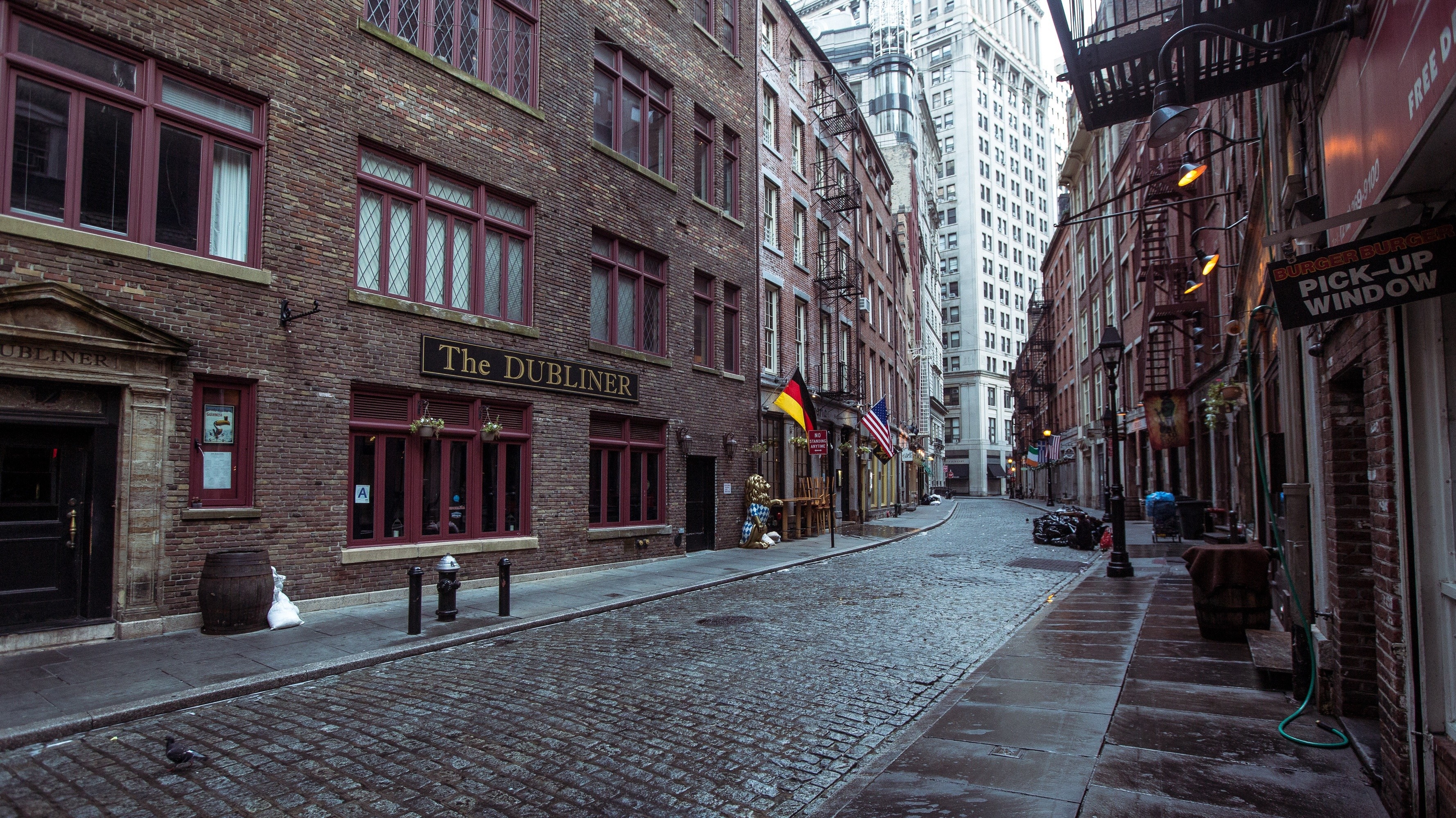 The Dubliner pub on a cobblestone street in a city HD Wallpaper