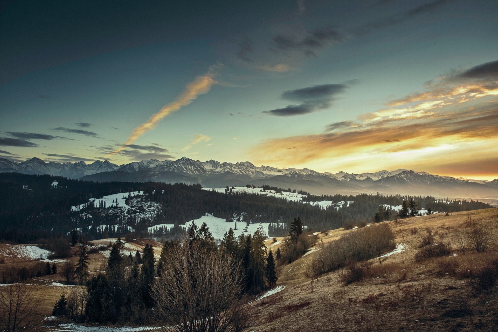 Mountain range at sunset with snow and clouds HD Wallpaper