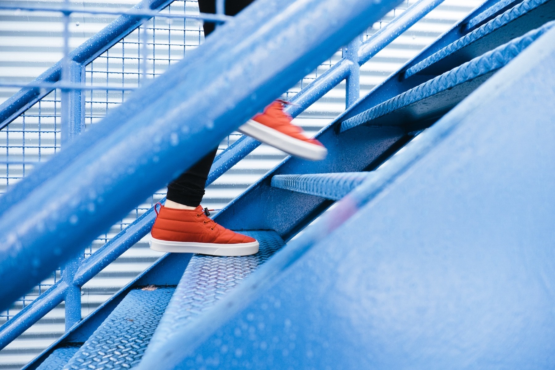 Person in red shoes climbing blue stairs HD Wallpaper