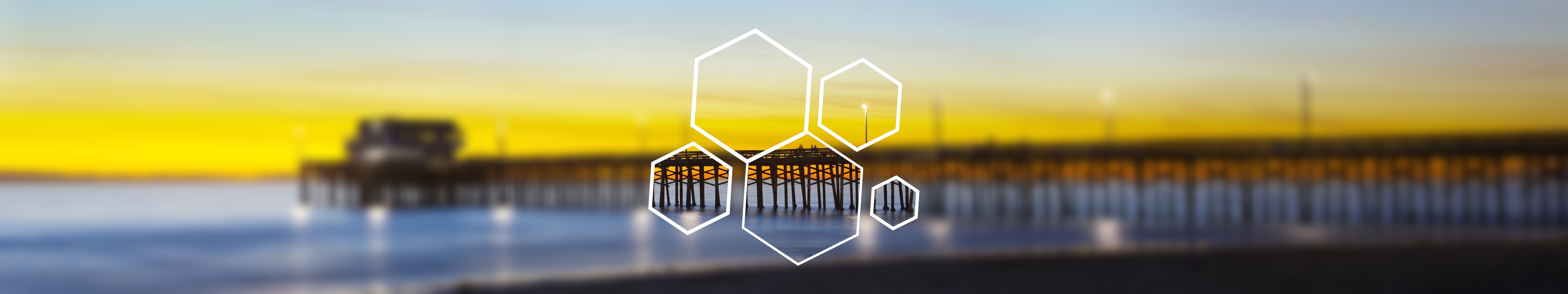 Blurred pier at sunset with hexagonal overlay HD Wallpaper