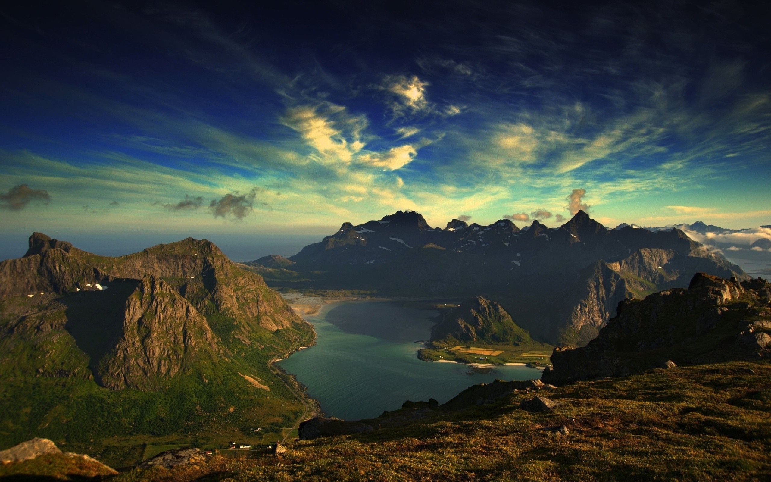 Mountain range overlooking a bay at sunset HD Wallpaper