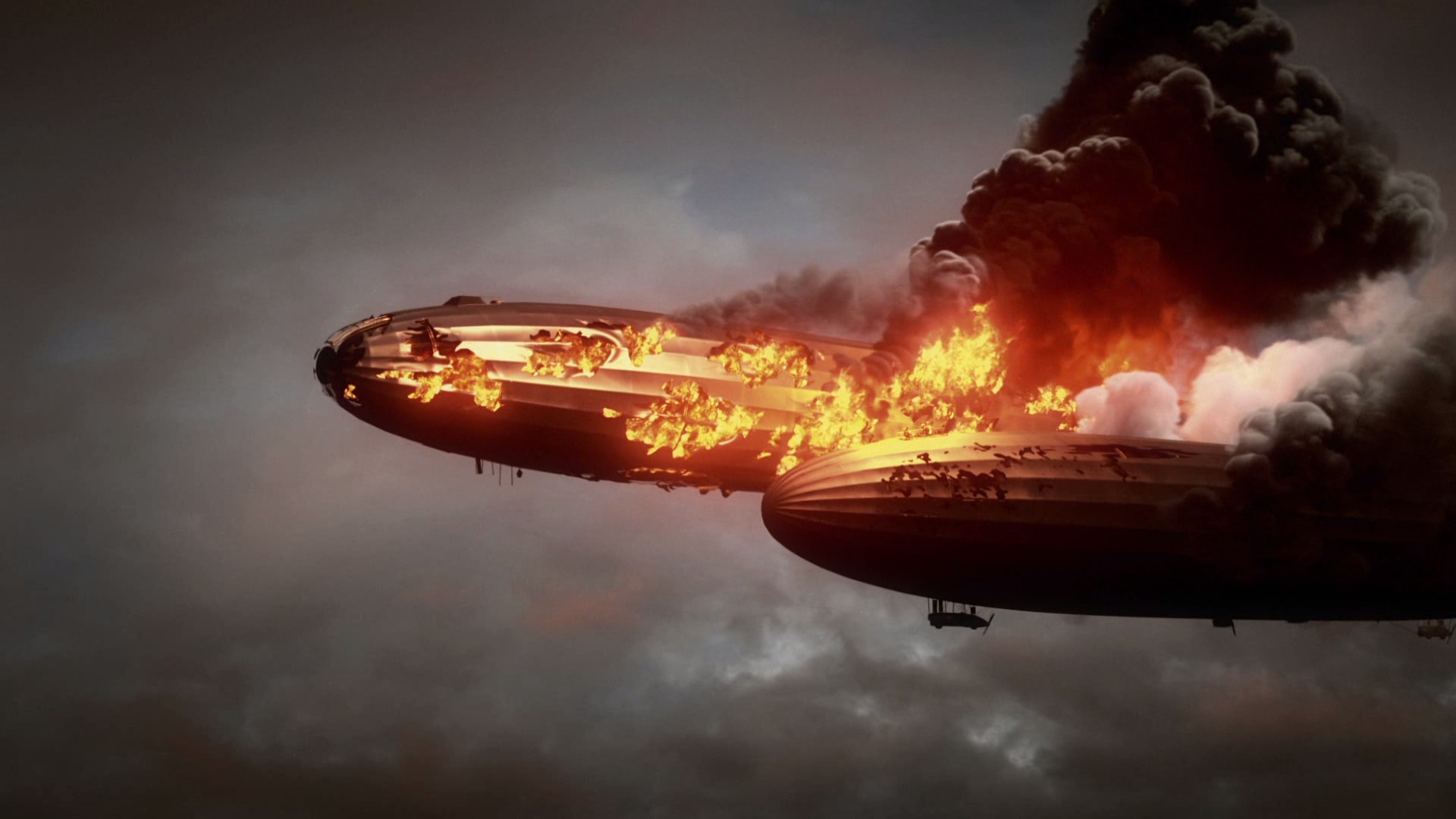 Two burning zeppelins in a cloudy sky HD Wallpaper