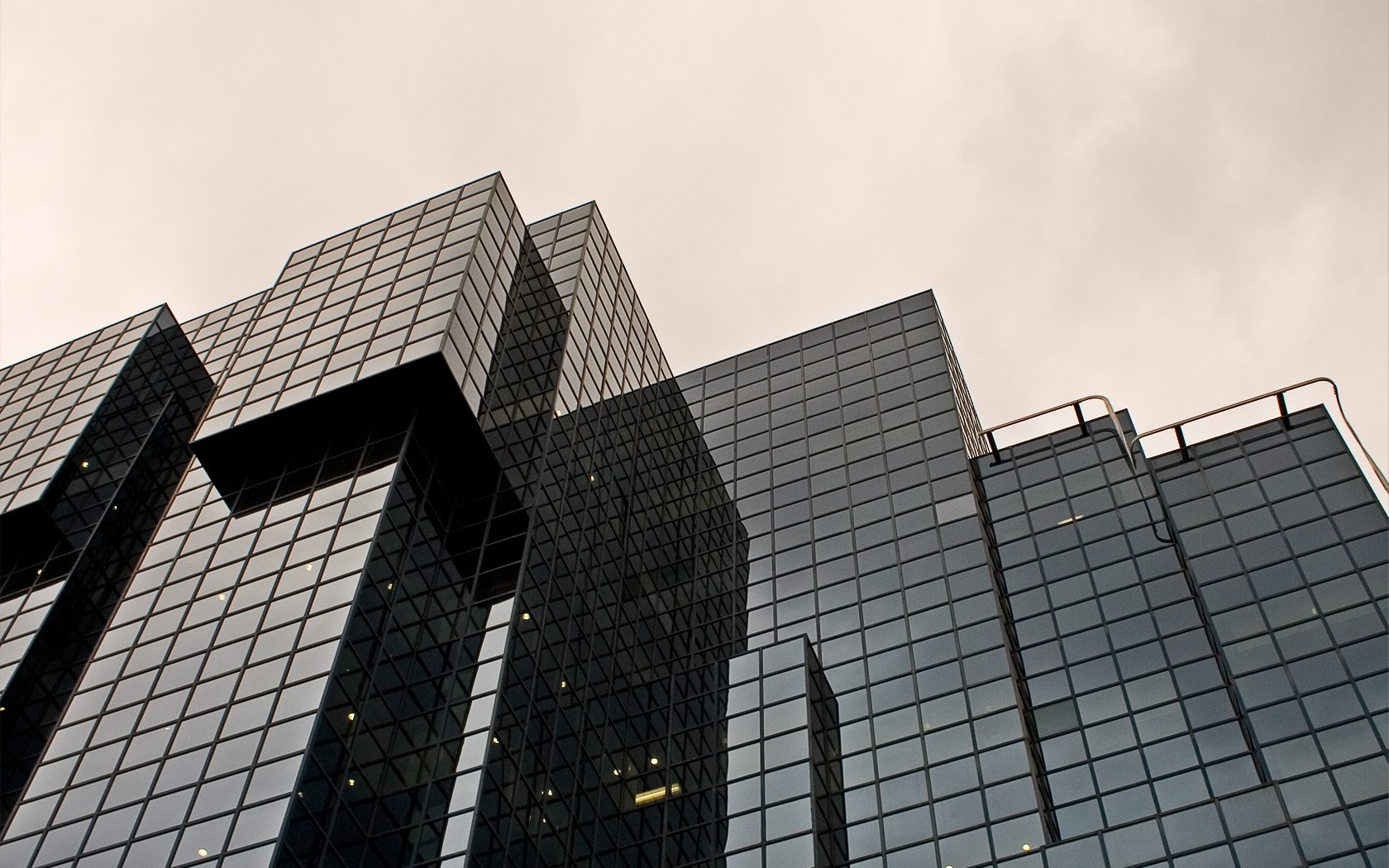 Modern glass skyscrapers against a cloudy sky HD Wallpaper
