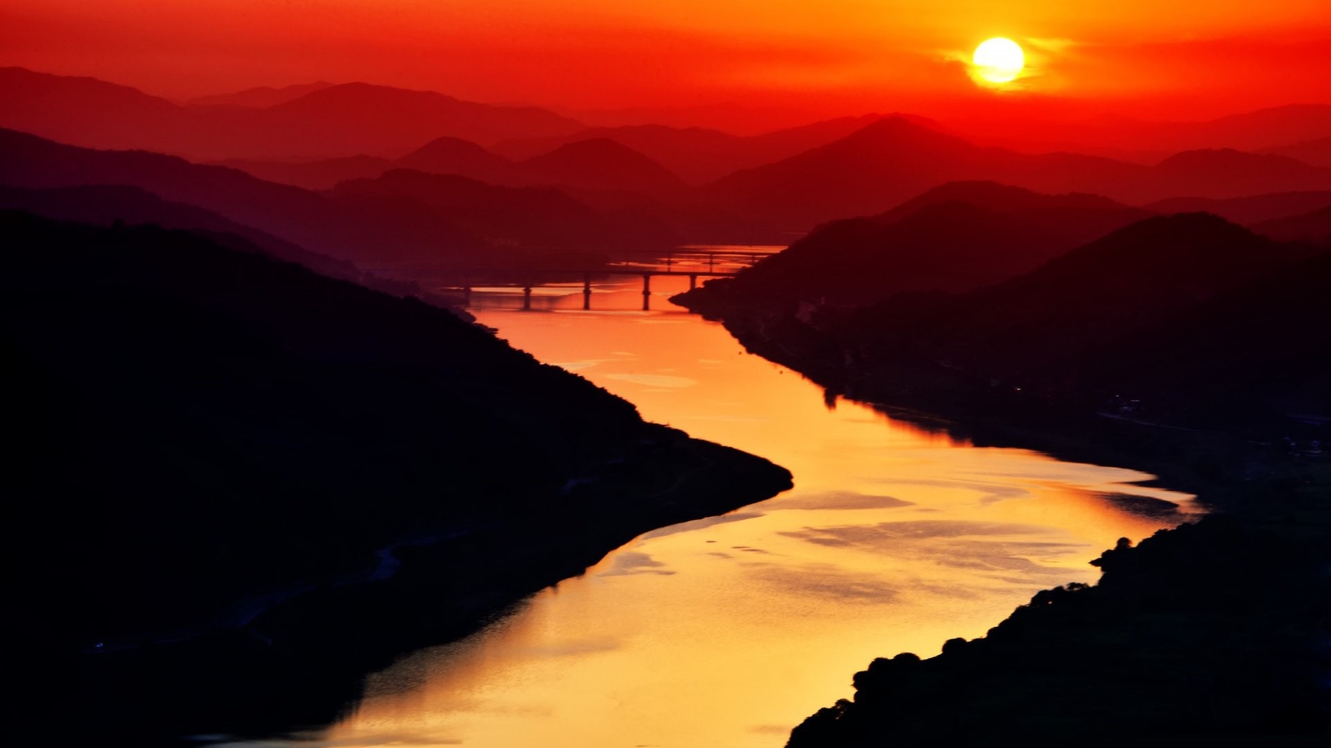 Sunset over mountains and river with bridge HD Wallpaper
