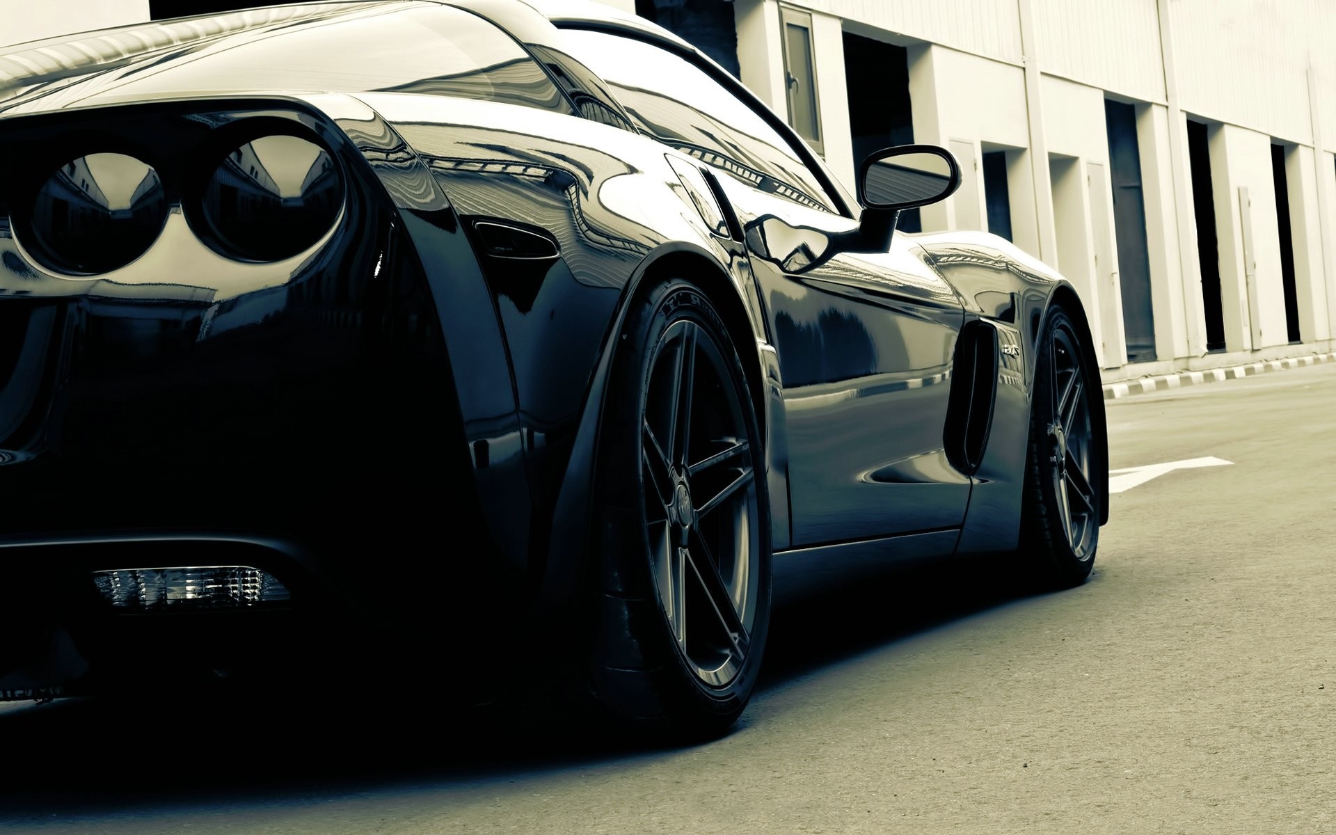 Black Chevrolet Corvette Z06 parked outside building HD Wallpaper