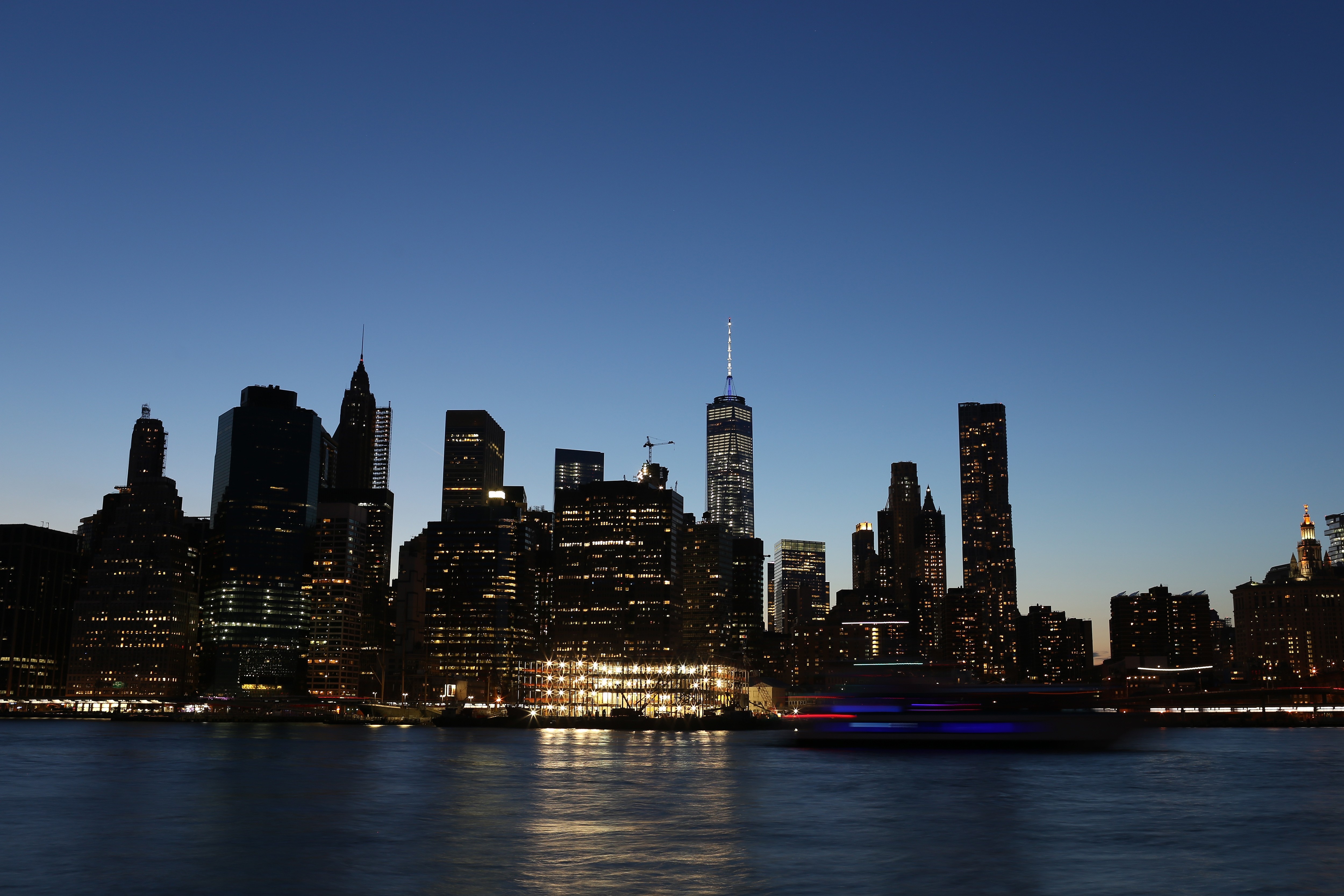New York City skyline at dusk with boat on water HD Wallpaper