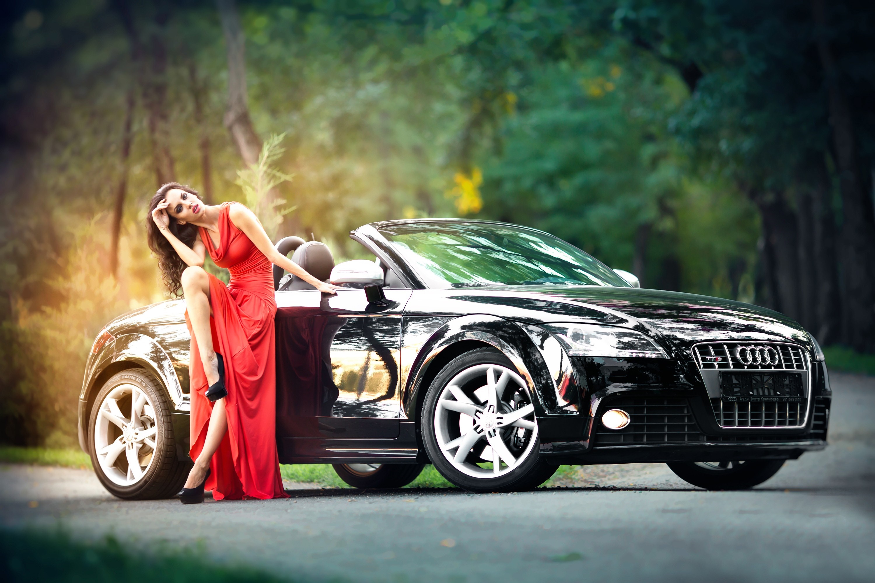 Woman in red dress posing with black Audi sports car HD Wallpaper