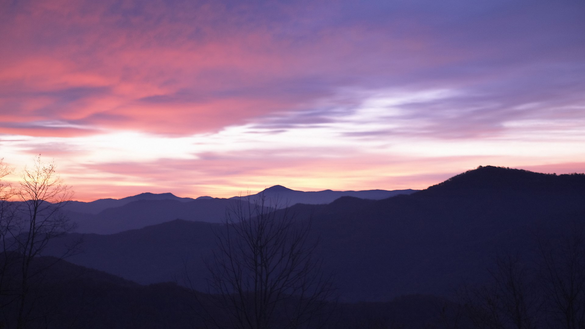 Purple and pink sunset over silhouetted mountains HD Wallpaper