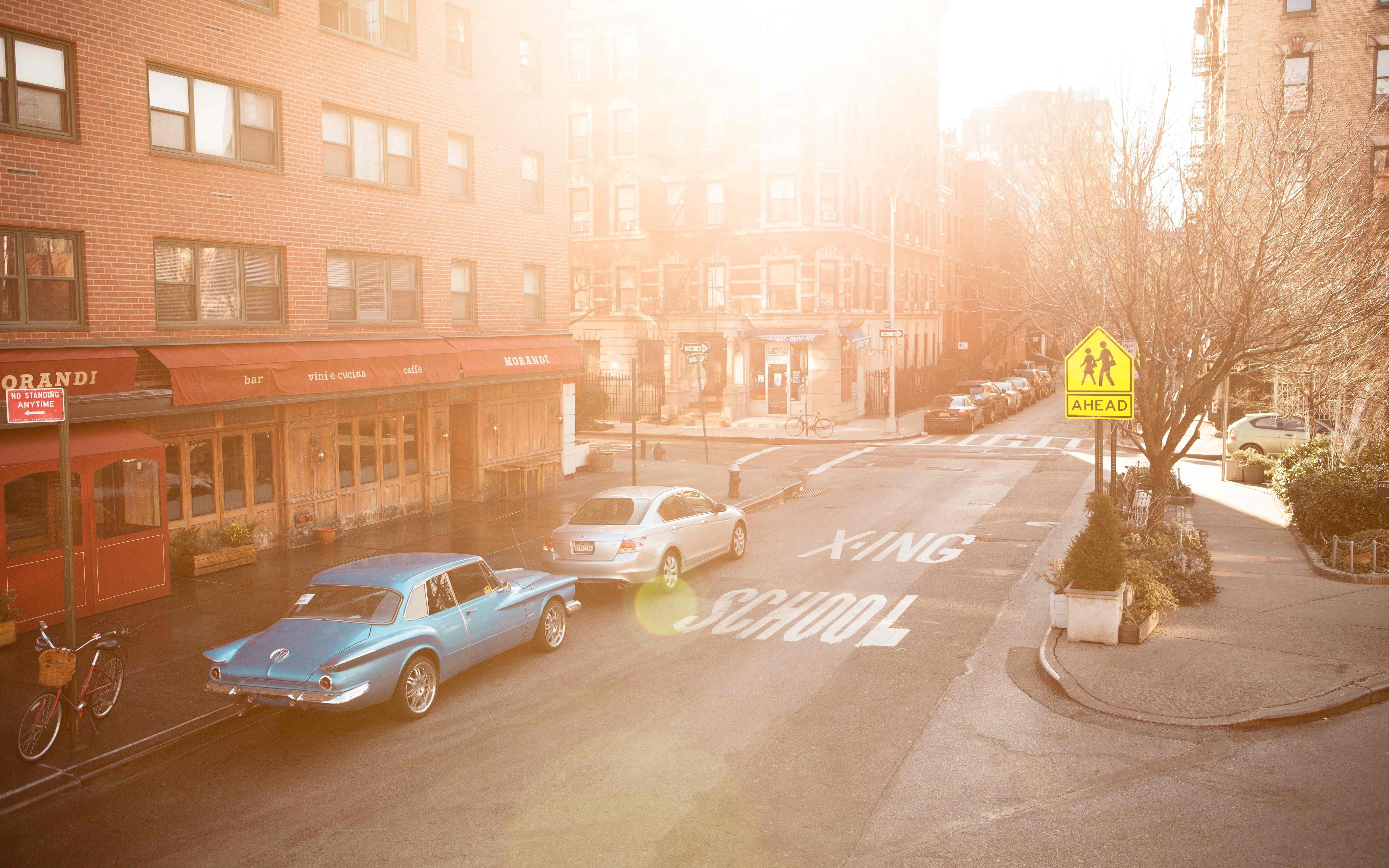 Blue vintage car on a sunny street with buildings HD Wallpaper